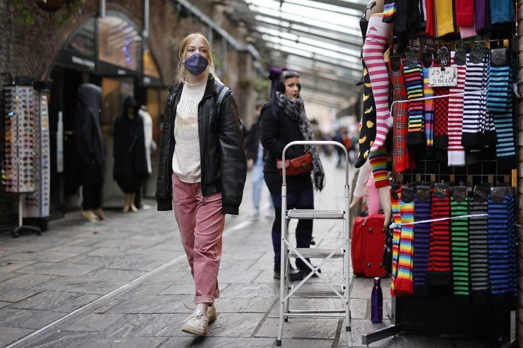 Shoppers walk past stores in Camden Market in London, on Jan 7. Photo: AFP 