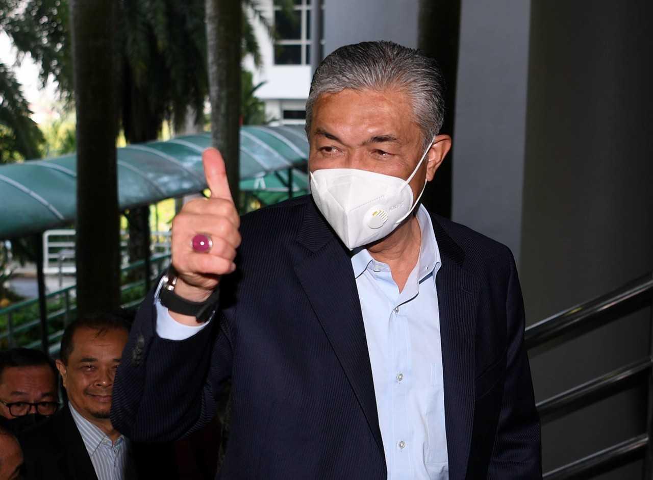 Former deputy prime minister Ahmad Zahid Hamidi gestures upon his arrival at the Shah Alam High Court today. Photo: Bernama
