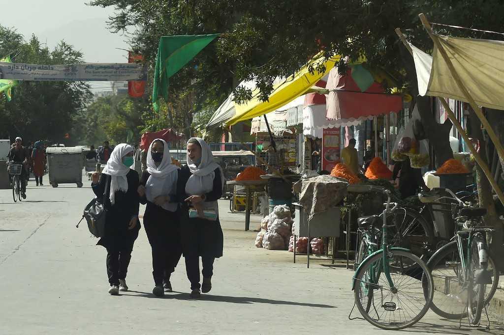 Afghan schoolgirls walk through in a street in Kabul on Aug 15. Photo: AFP