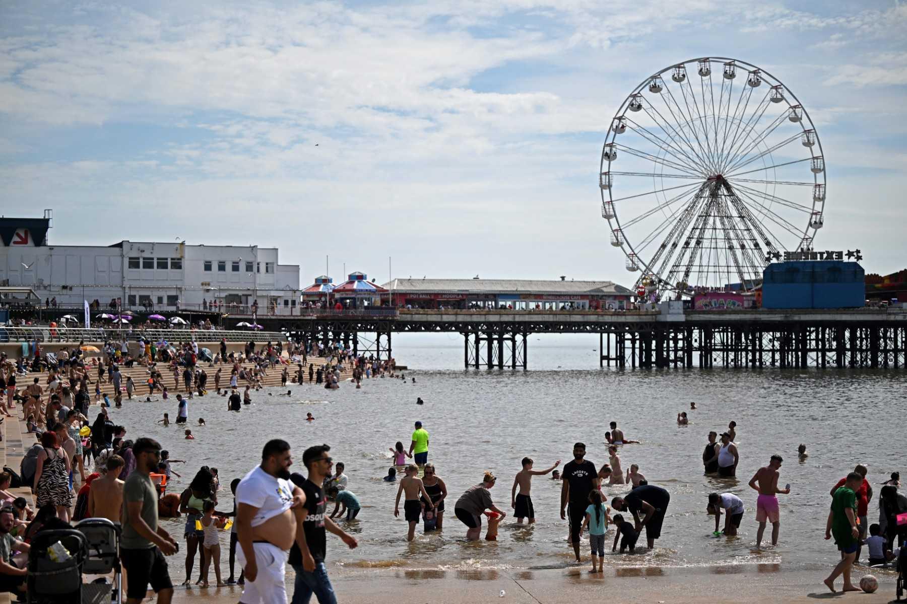 Beachgoers enjoy the sun and the sea at Blackpool, north west England on July 17. Photo: AFP