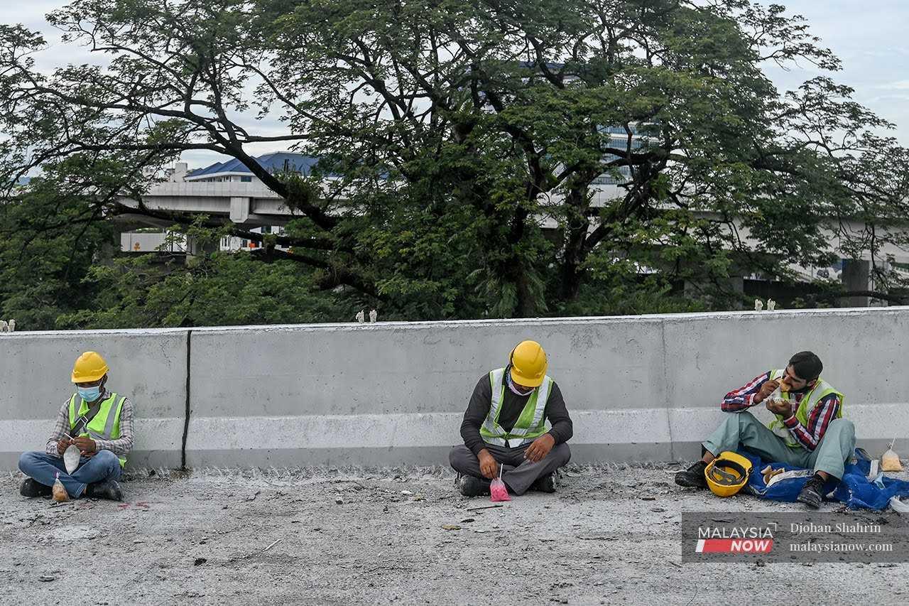 Pekerja asing berehat seketika di sebuah tapak bina di Kuala Lumpur.
