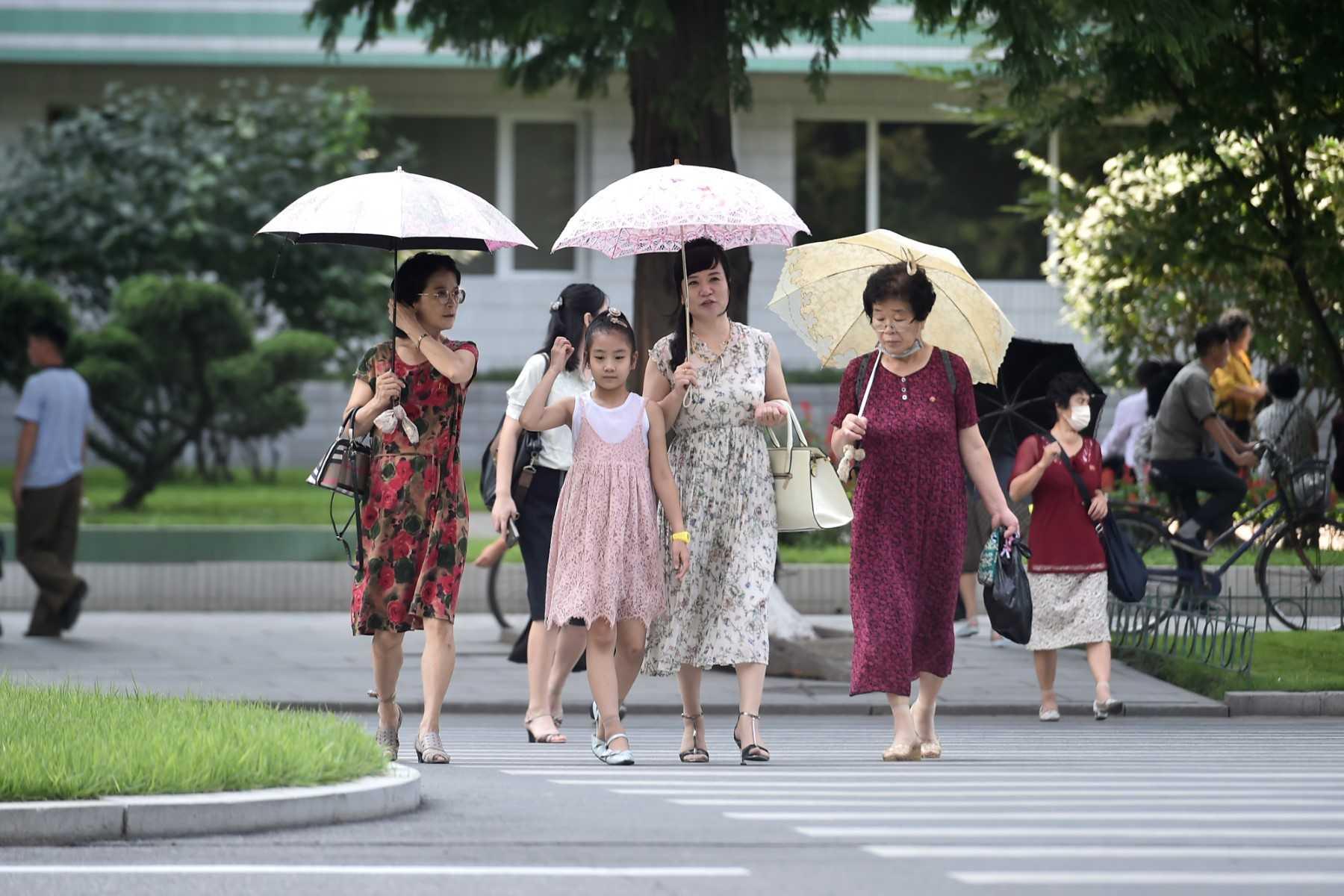 Pedestrians walk along Ryomyong street in Pyongyang on Aug 12. North Korea has never confirmed how many people caught Covid, apparently due to a lack of means to conduct widespread testing. Photo: AFP