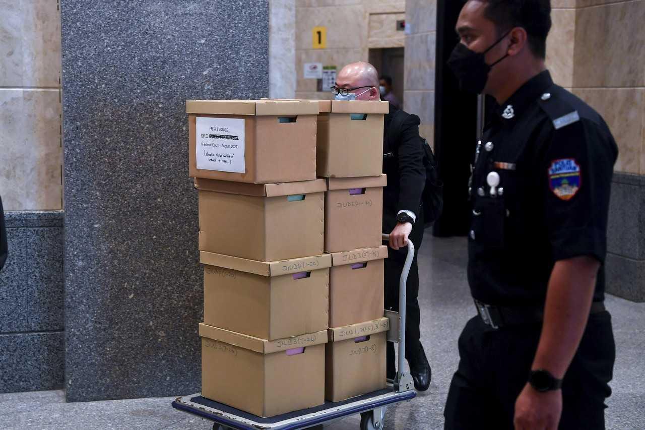 Boxes containing allegedly new evidence in the appeal hearing of former prime minister Najib Razak are wheeled out of the Federal Court after the first day of his hearing today. Photo: Bernama
