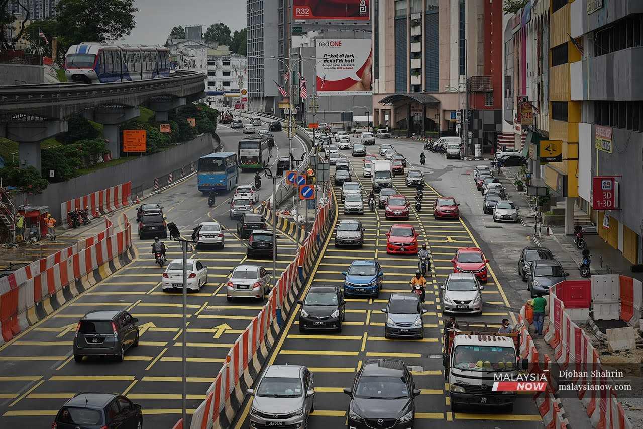 Drivers make their way through the capital city of Kuala Lumpur. 
