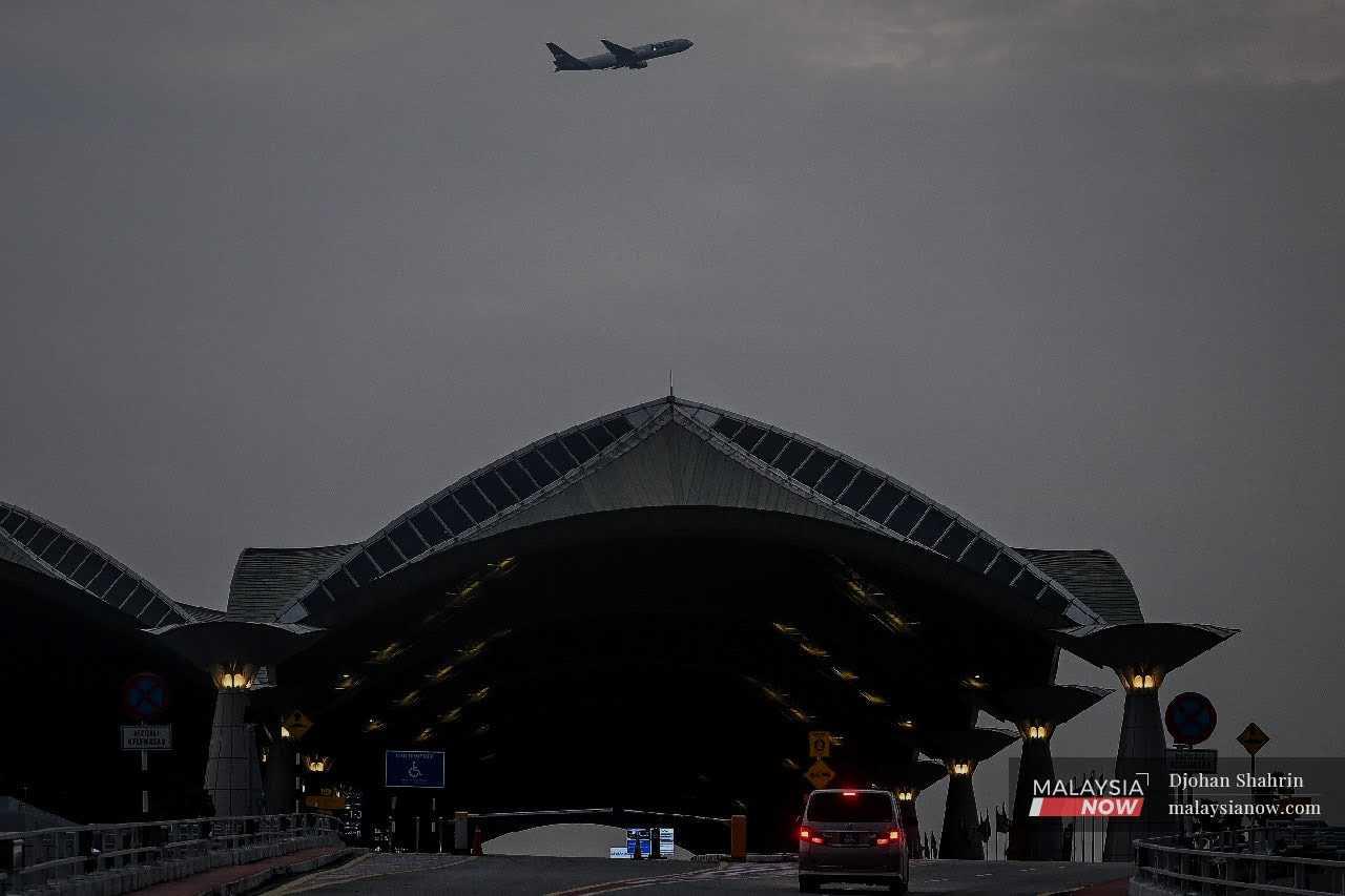A plane passes over KLIA in Sepang in this file picture. 