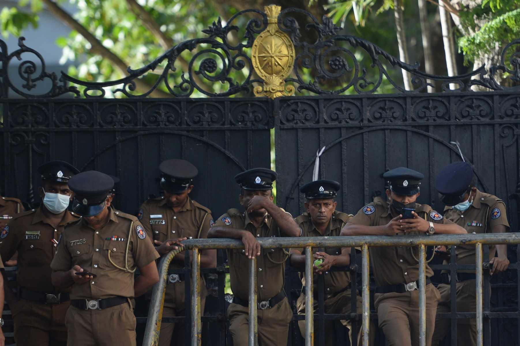 Police stand guard at an entrance gate of the Sri Lankan President’s official residence in Colombo on July 15, after it was overrun by anti-government protestors on July 9. Photo: AFP