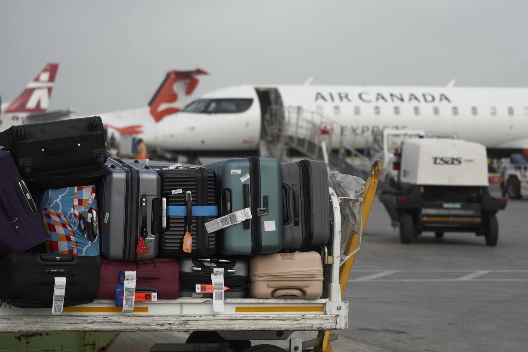 Baggage sits on a cart on the tarmac at Pierre Elliott Trudeau International Airport in Montreal, Quebec, on May 16. Photo: AFP