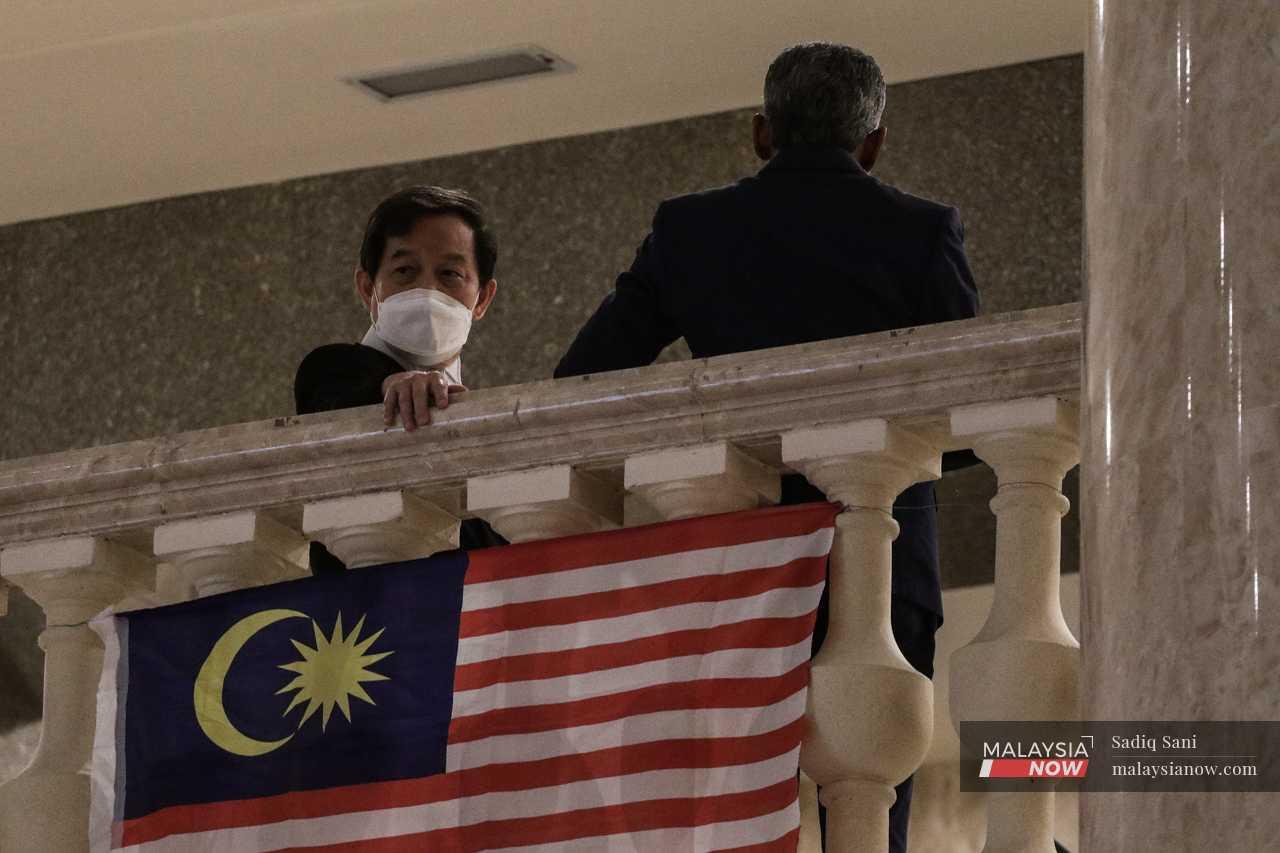 Najib's lead lawyer, Hisyam Teh Poh Teik, looks down over the railing outside the courtroom. 
