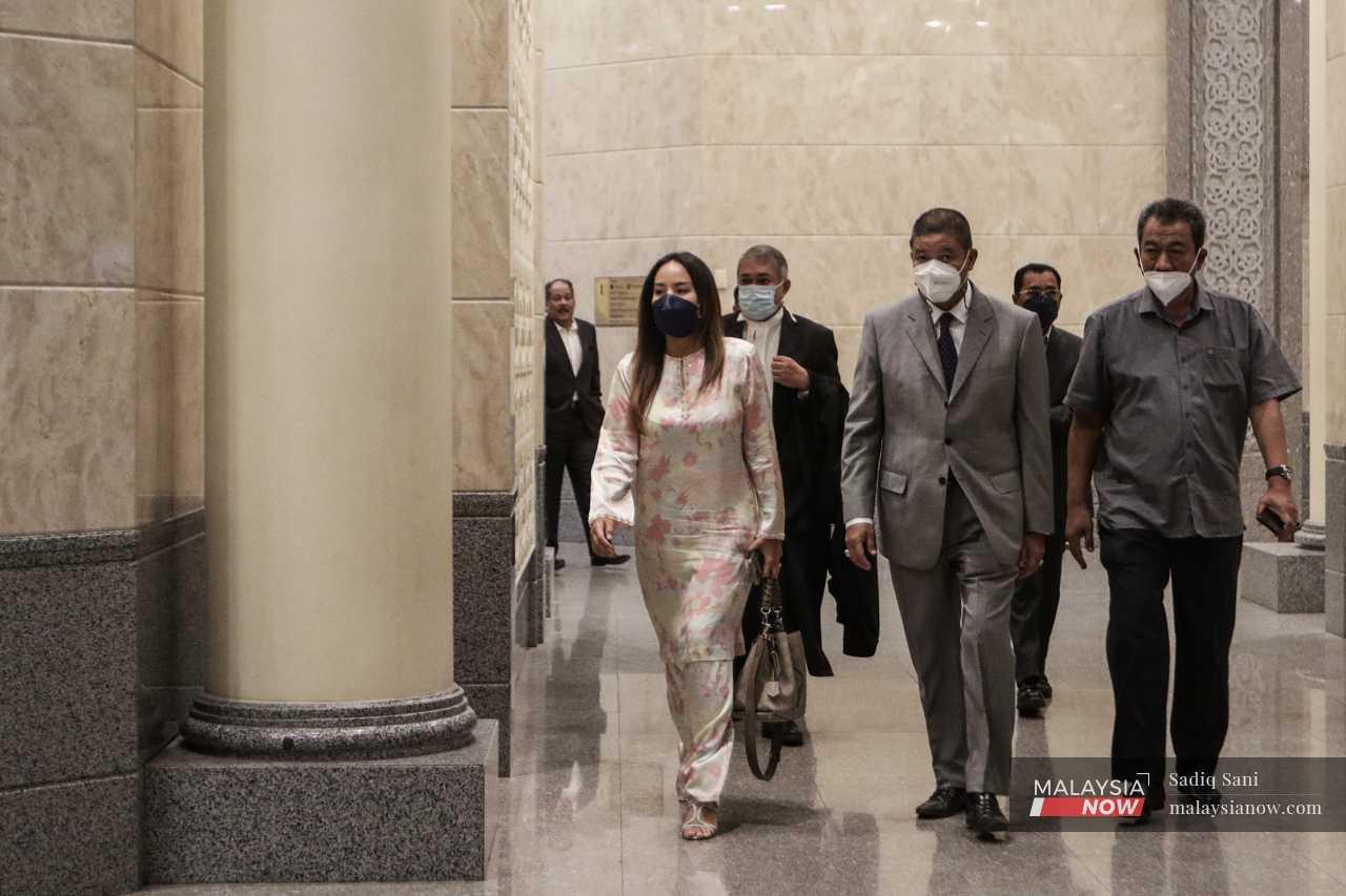 Najib's daughter, Nooryana Najwa, is escorted to the courtroom. 