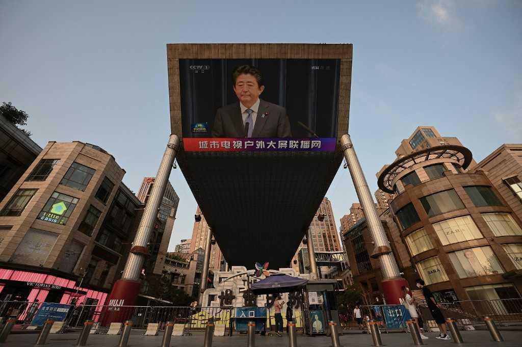 A large video screen shows news broadcast featuring an image of former Japanese prime minister Shinzo Abe in Beijing on July 8. Abe was pronounced dead on July 8 after he was shot at a campaign event in the city of Nara. Photo: AFP