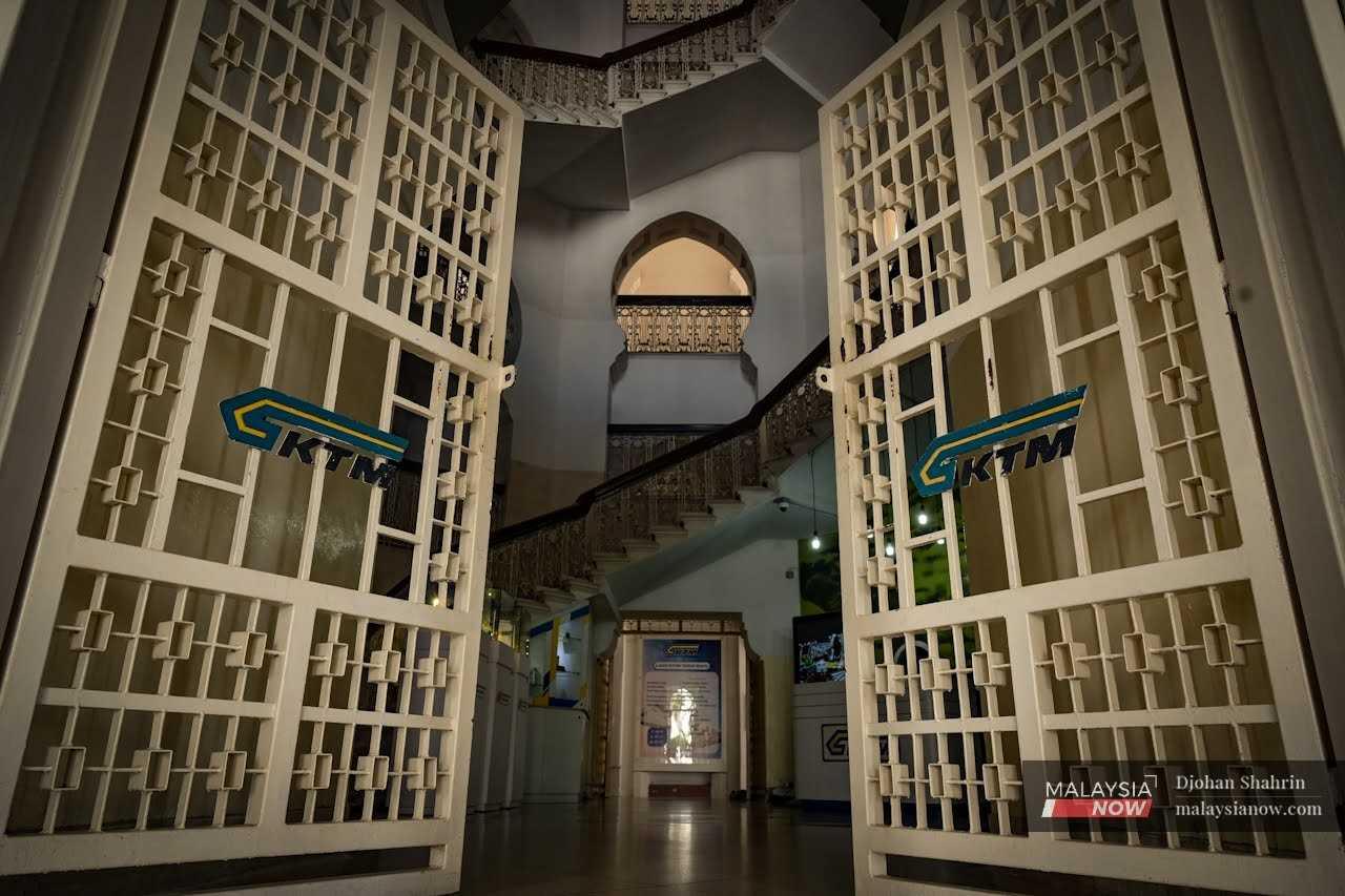 The gates of the administration building swing open to reveal the lobby inside. 
