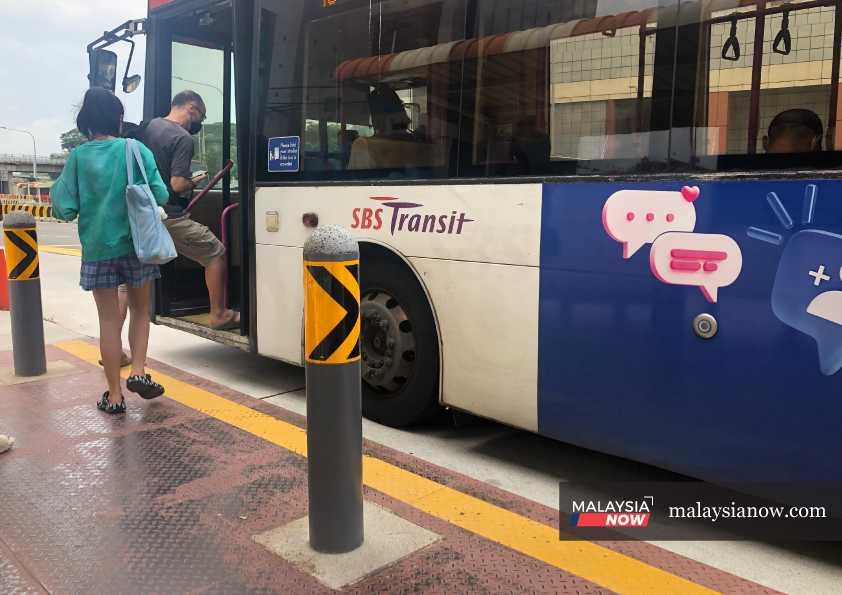 Beberapa penumpang menaiki bas awam SBS Transit di Singapura.
