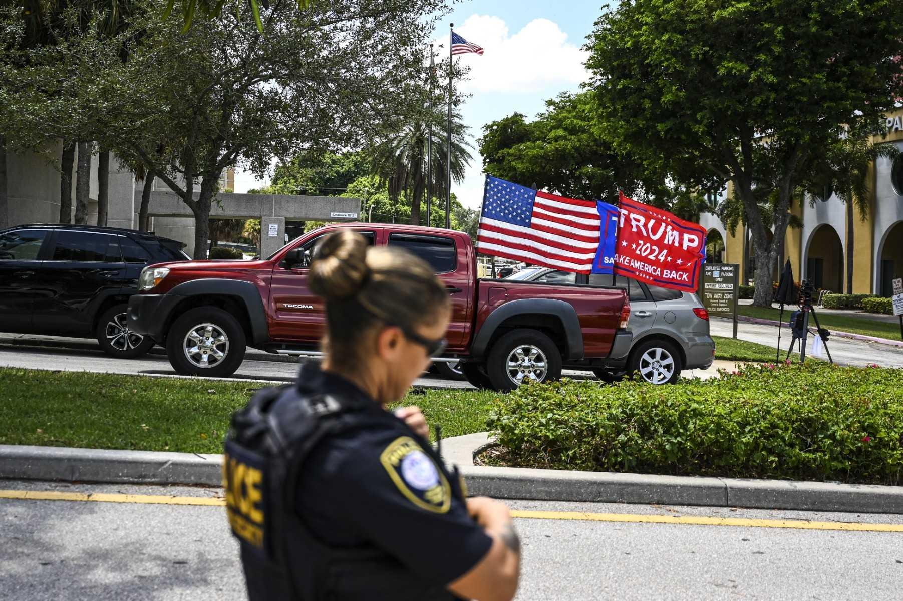 Supporters of former US president Donald Trump drive around the courthouse as the court holds a hearing to determine if the affidavit used by the FBI as justification for the search of Trump's Mar-a-Lago estate should be unsealed, at the US District Courthouse for the Southern District of Florida in West Palm Beach, Florida on Aug 18. Photo: AFP