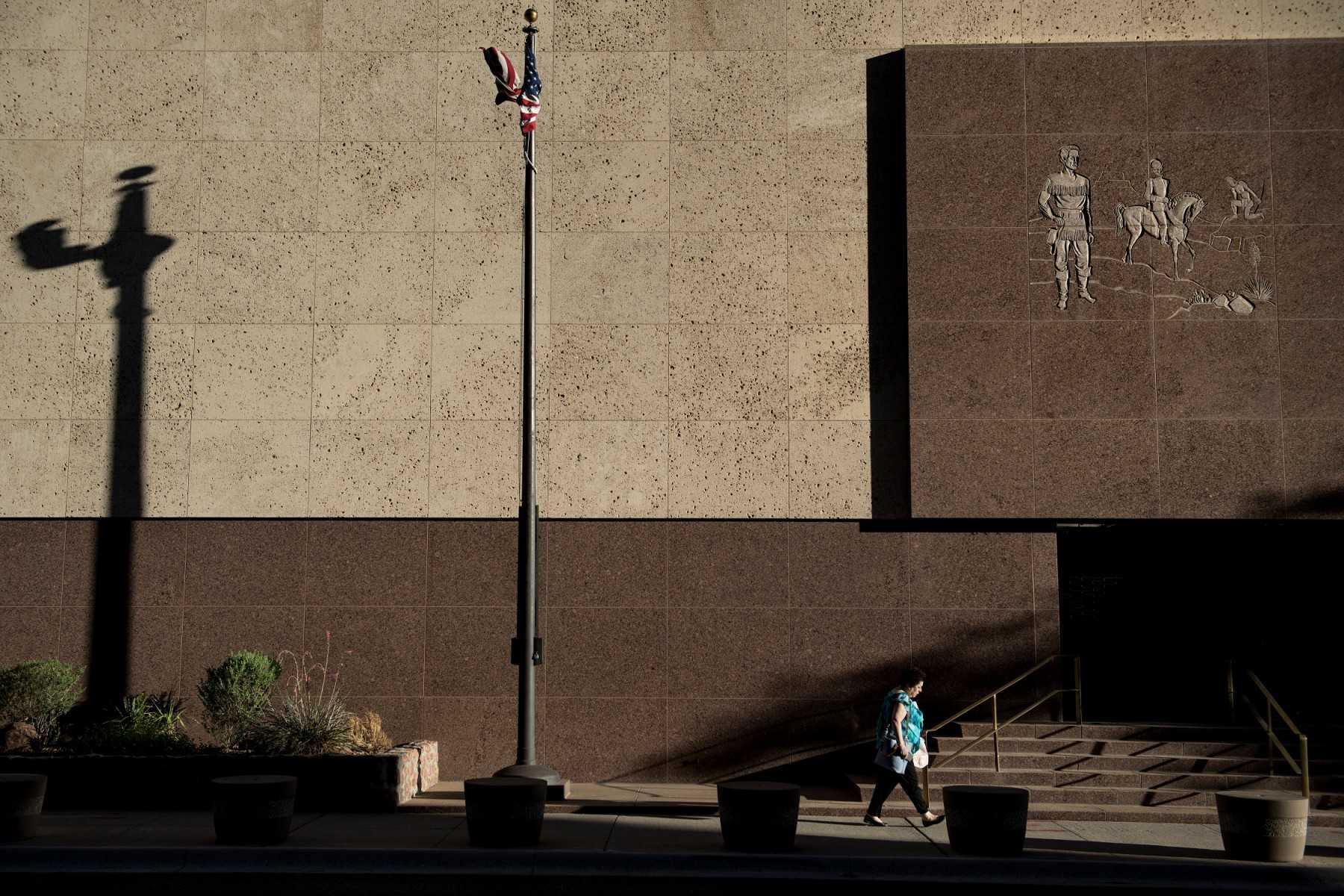 A woman walks past the Federal Reserve building on June 20, 2018 in El Paso, Texas. Photo: AFP