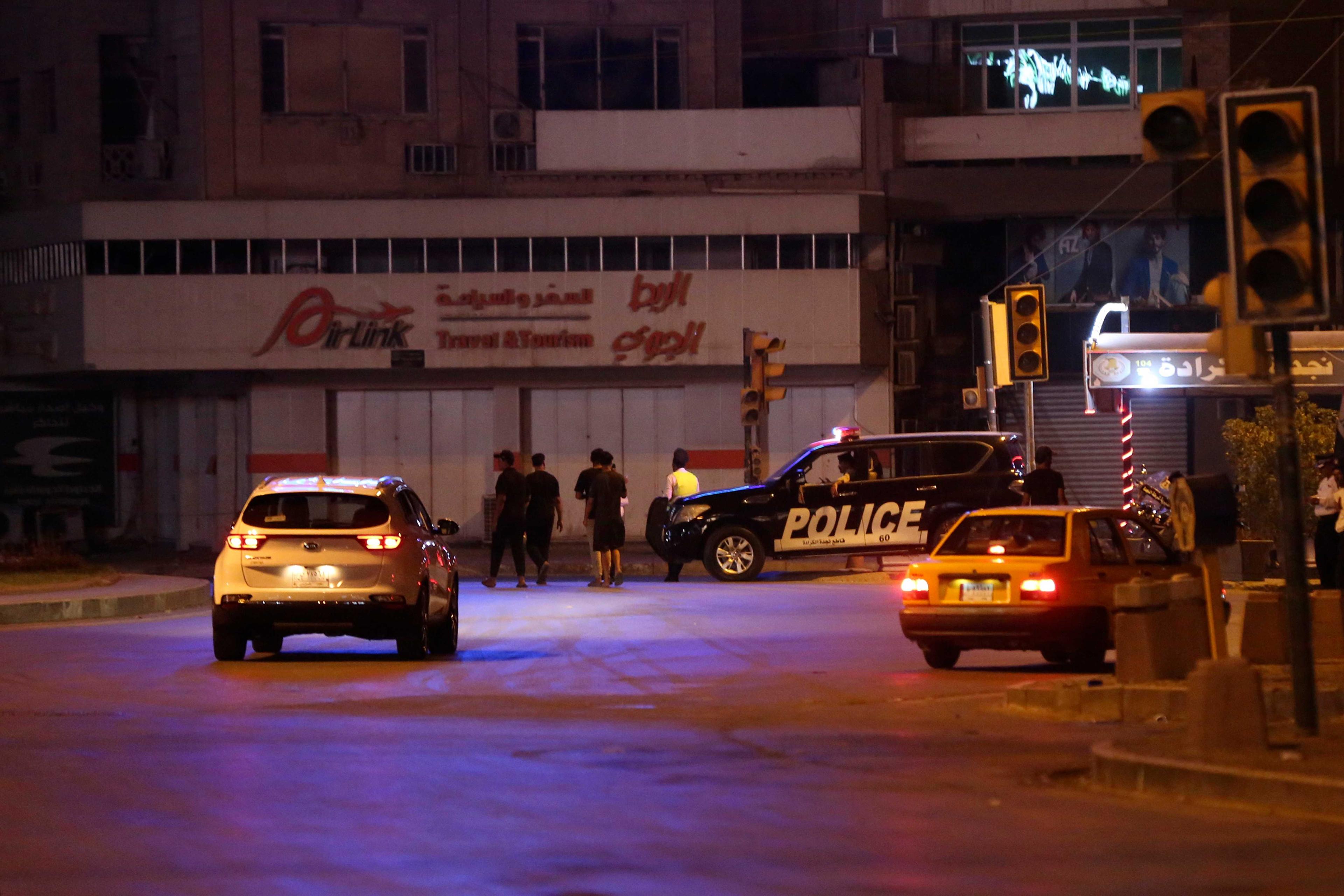 Iraqis make their way back home in the capital Baghdad on Aug 29, after a full curfew was announced by the Iraqi army. Photo: AFP