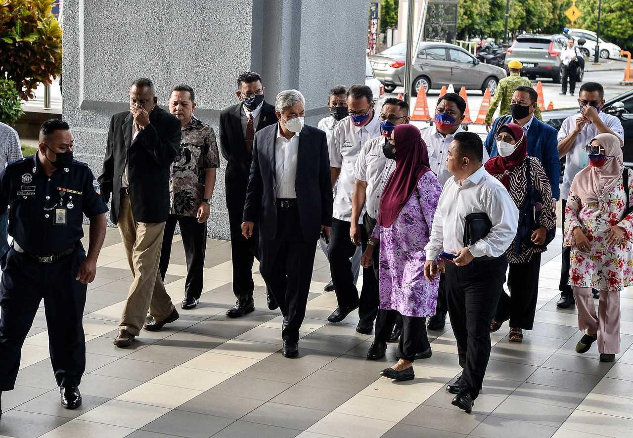 Former deputy prime minister Ahmad Zahid Hamidi (fifth right) arrives at the Kuala Lumpur court complex today. Photo: Bernama
