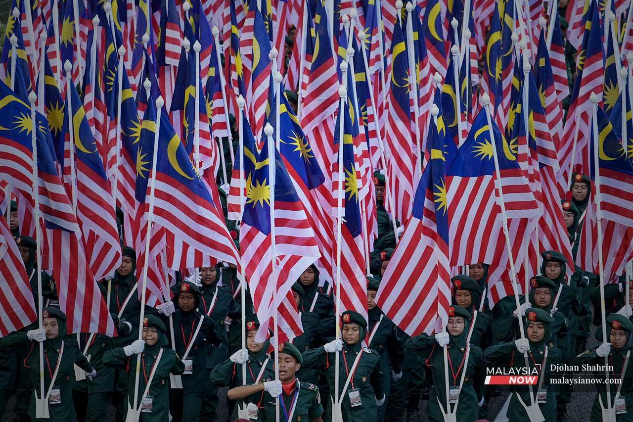 Others hold more flags, creating a sea of red, white, blue and yellow. 