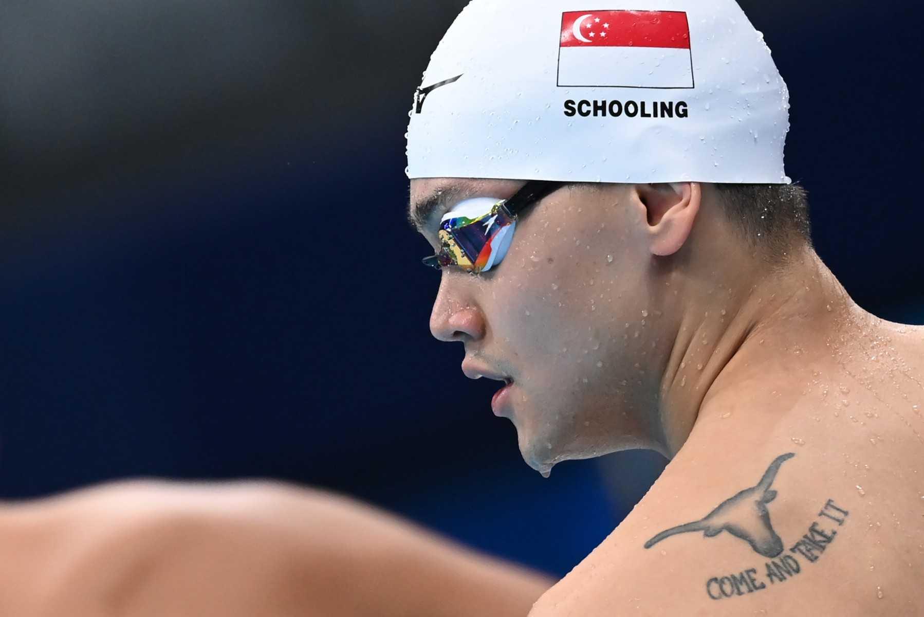 A tattoo is seen on the back of Singapore's Joseph Schooling as he prepares to compete in a heat for the men's 100m freestyle swimming event during the Tokyo 2020 Olympic Games at the Tokyo Aquatics Centre in Tokyo on July 27, 2021. Photo: AFP