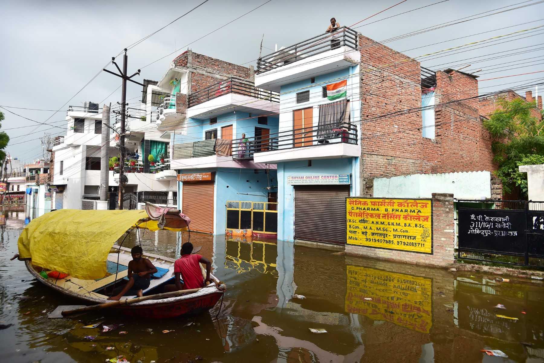 Residents look out from their home in a flooded residential area in Allahabad on Aug 26, following heavy monsoon rains that caused the overflowing of the Ganges and Yamuna Rivers. Photo: AFP 