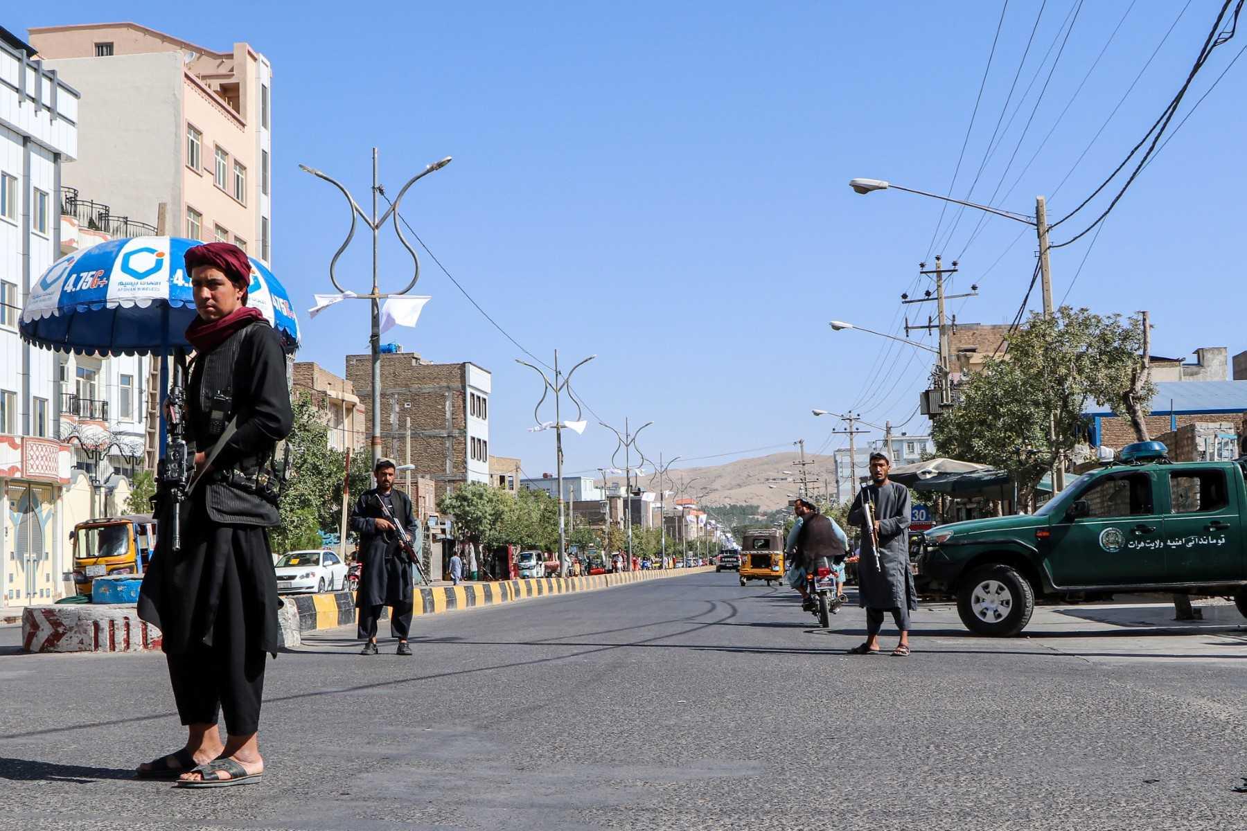 Taliban fighters stand guard at a checkpoint in Herat on Aug 15. Photo: AFP