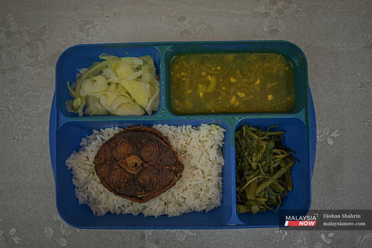 Each prisoner gets an equal share of rice, vegetables, soup, and in this case, fried fish. 
