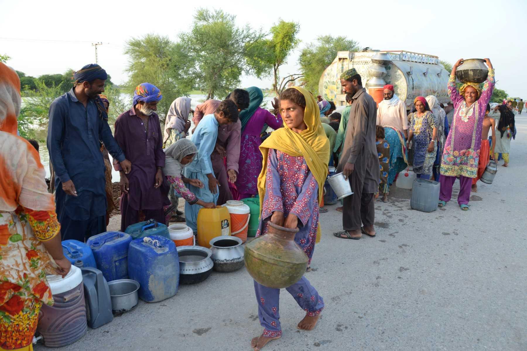 Flood victims gather to collect drinking water from a tanker in a flood-hit area following heavy rains in Dera Allah Yar town in Jaffarabad district, Balochistan province, Pakistan on Sept 6. Photo: AFP