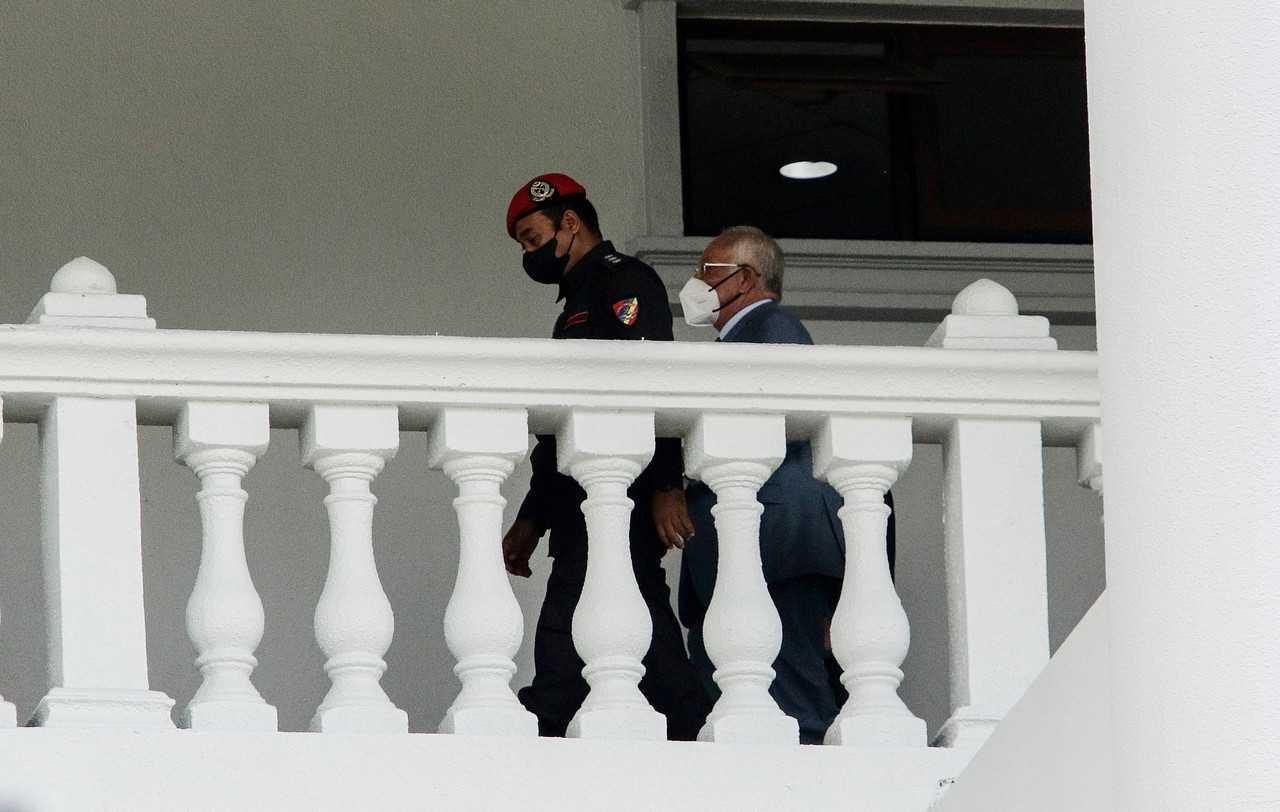Former prime minister Najib Razak is escorted at the Kuala Lumpur court complex today. Photo: Bernama
