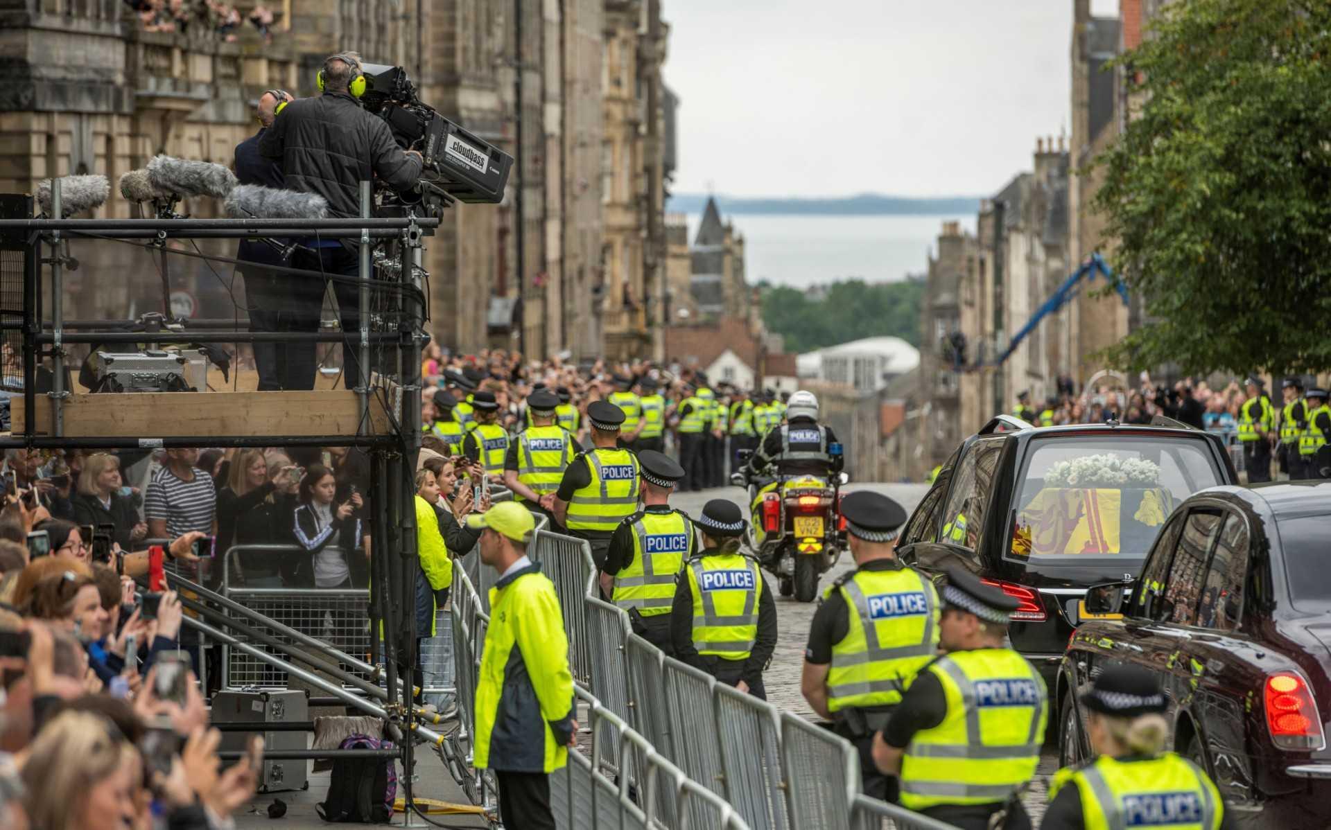 The hearse carrying the coffin of Queen Elizabeth II, draped in the Royal Standard of Scotland, is driven along the Royal Mile in Edinburgh, en-route towards the Palace of Holyroodhouse, on Sept 11. Photo: AFP