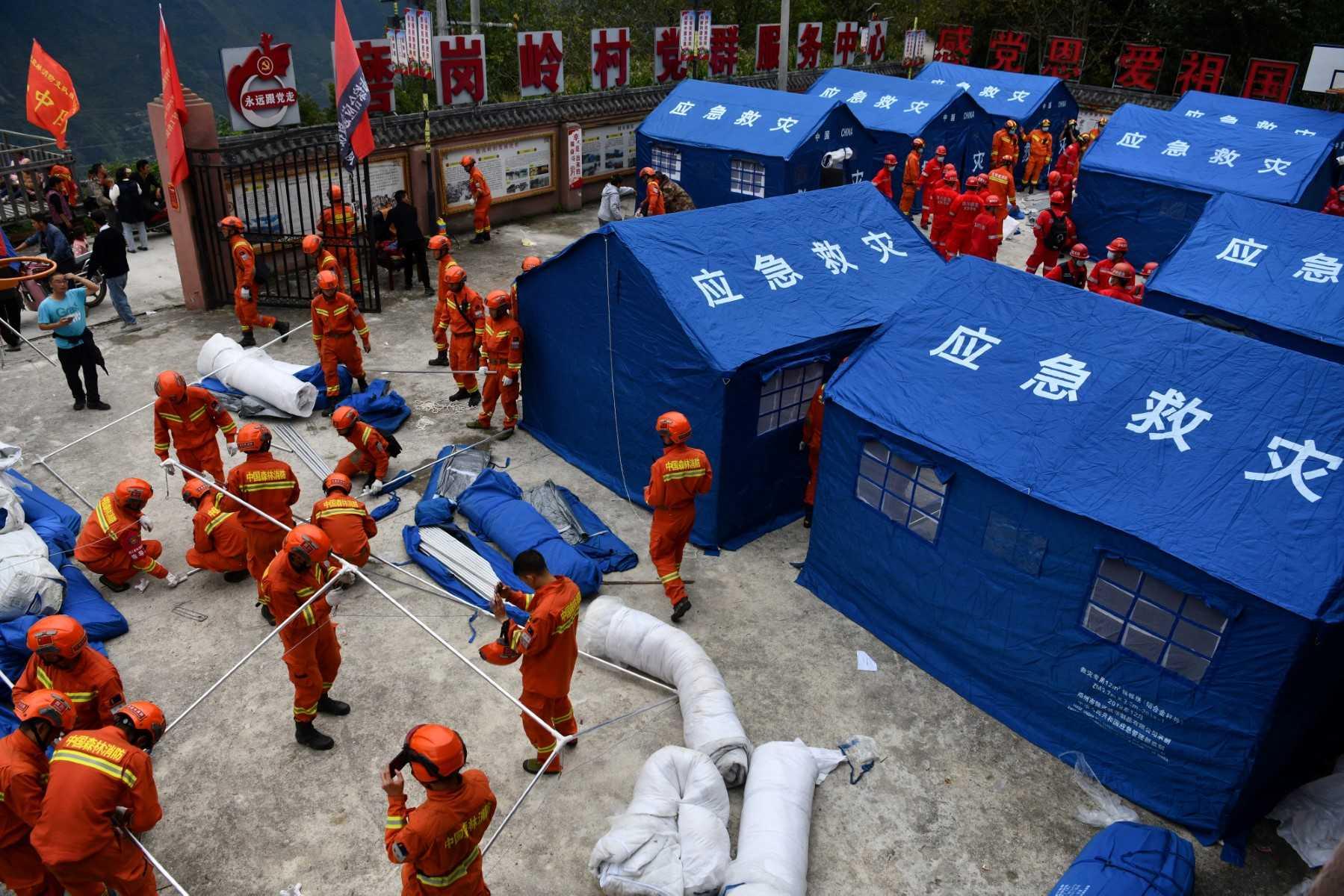 This photo taken on Sept 7 shows rescuers setting up tents for people displaced after a 6.6-magnitude earthquake that struck Sept 5, in Luding county, Ganzi Prefecture, in China's southwestern Sichuan province. Photo: AFP 