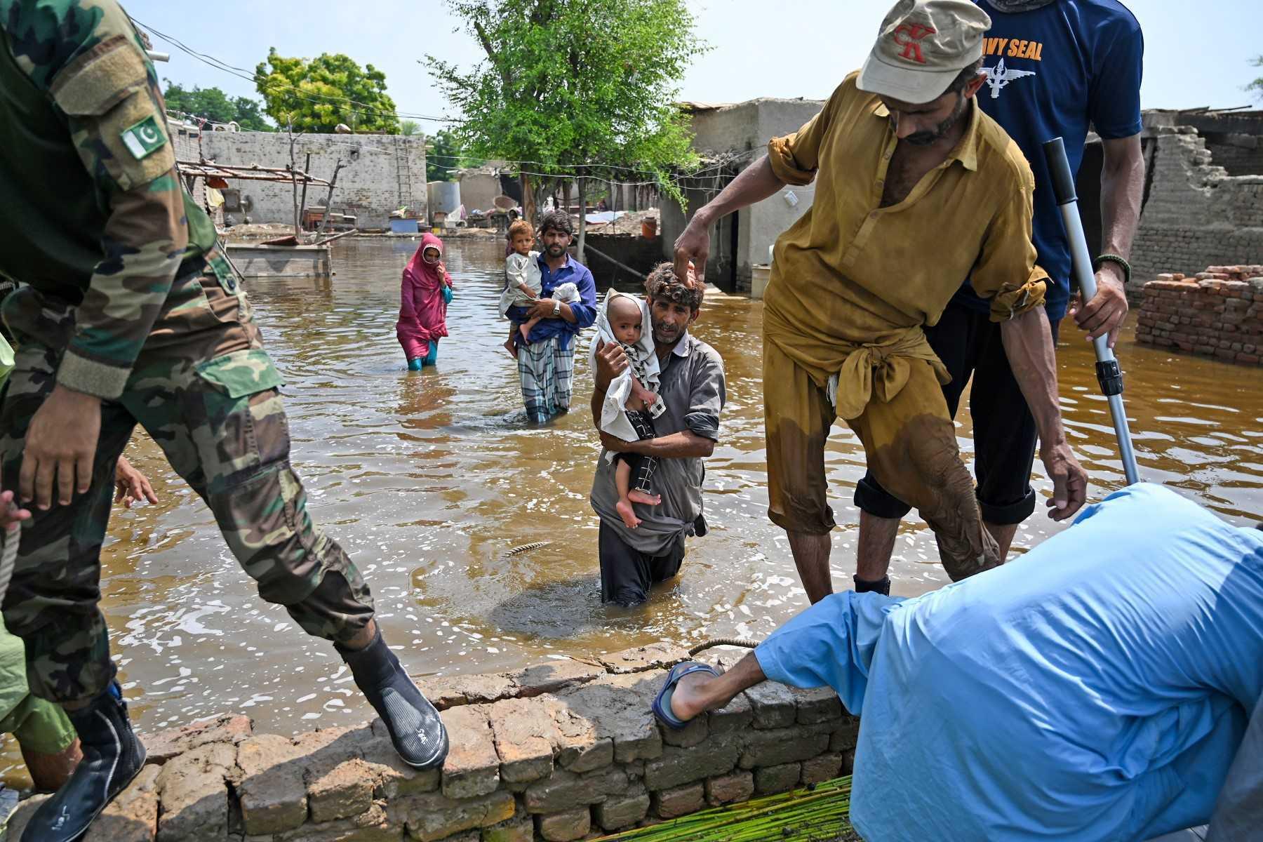 Pakistan's navy personnel rescue flood-affected people from their damaged houses after heavy monsoon rains in Dadu district, Sindh province on Sept 7. Photo: AFP