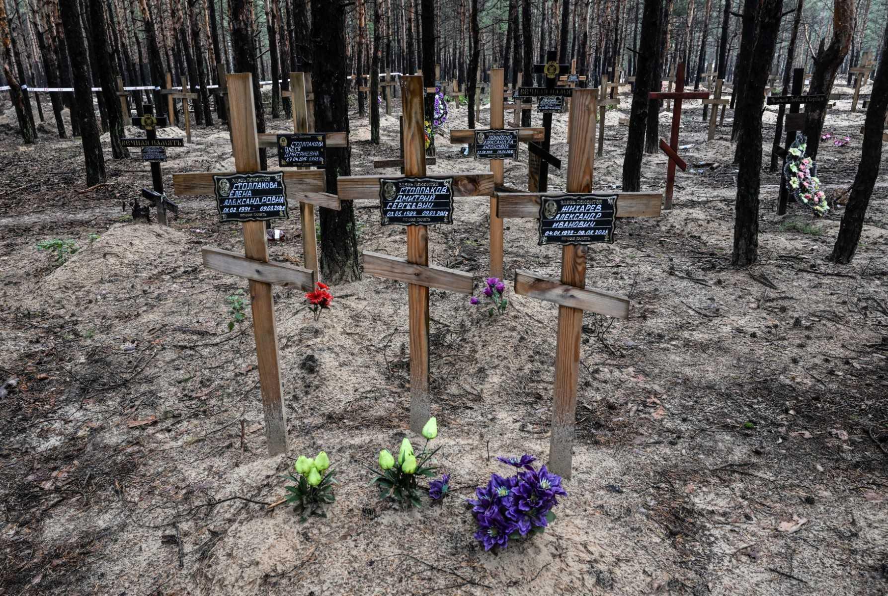 A photo shows crosses at a burial site in a forest on the outskirts of Izyum, on Sept 17. Photo: AFP