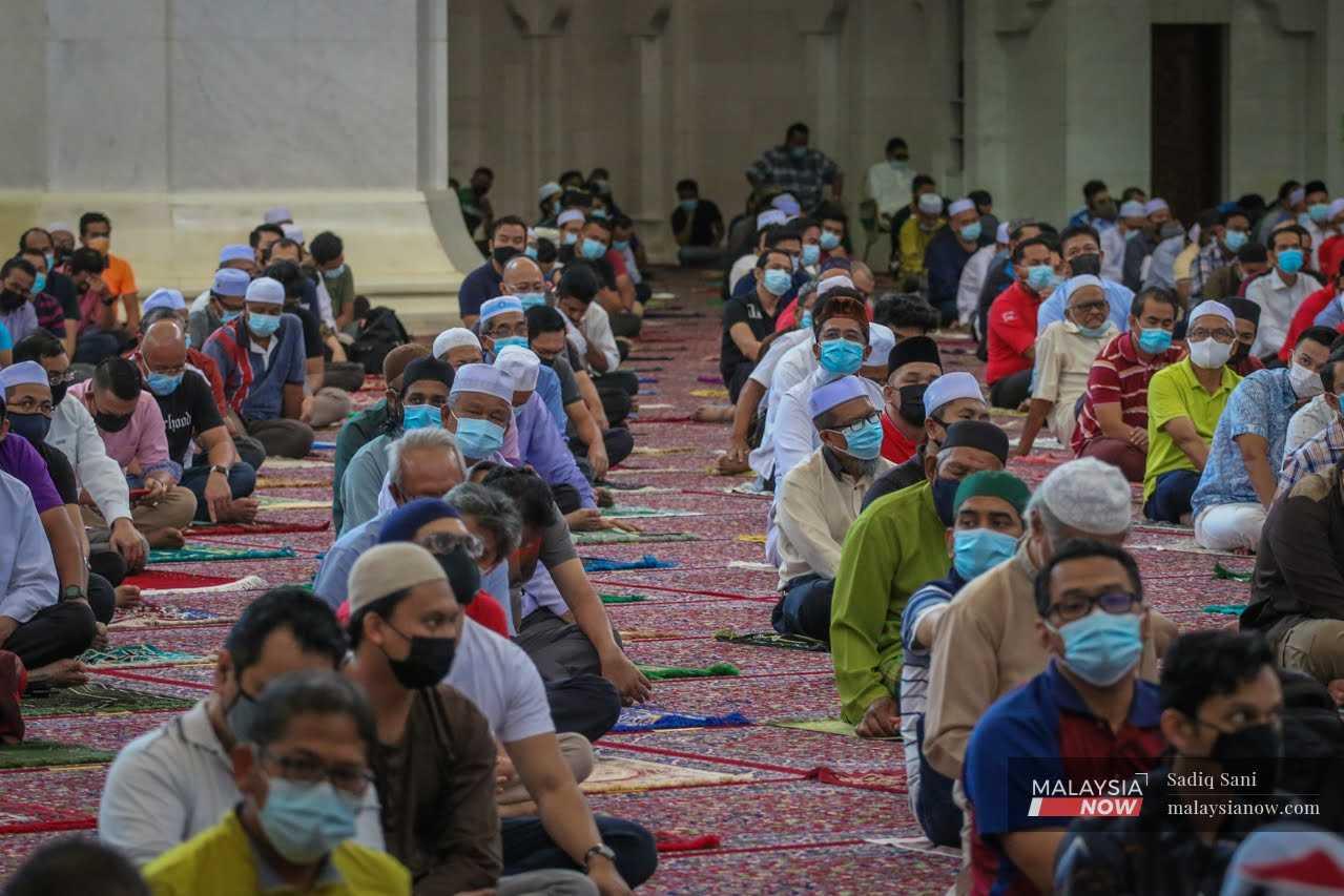 Muslims wait to perform their Friday prayers at Masjid Wilayah in Kuala Lumpur. 
