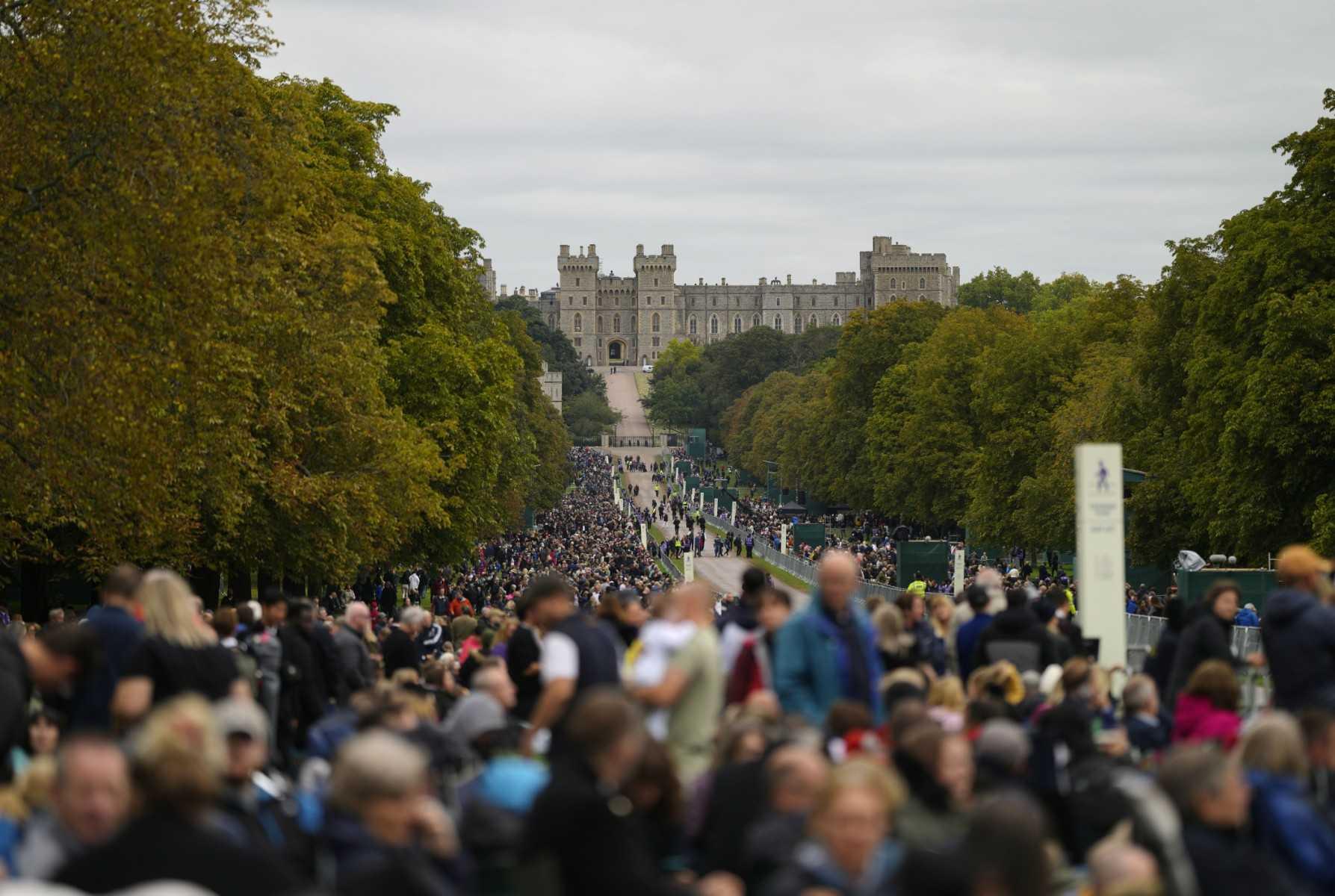 People stand along the Long Walk outside Windsor Castle ahead of the State Funeral of Queen Elizabeth II in Windsor on Sept 19. Photo: AFP