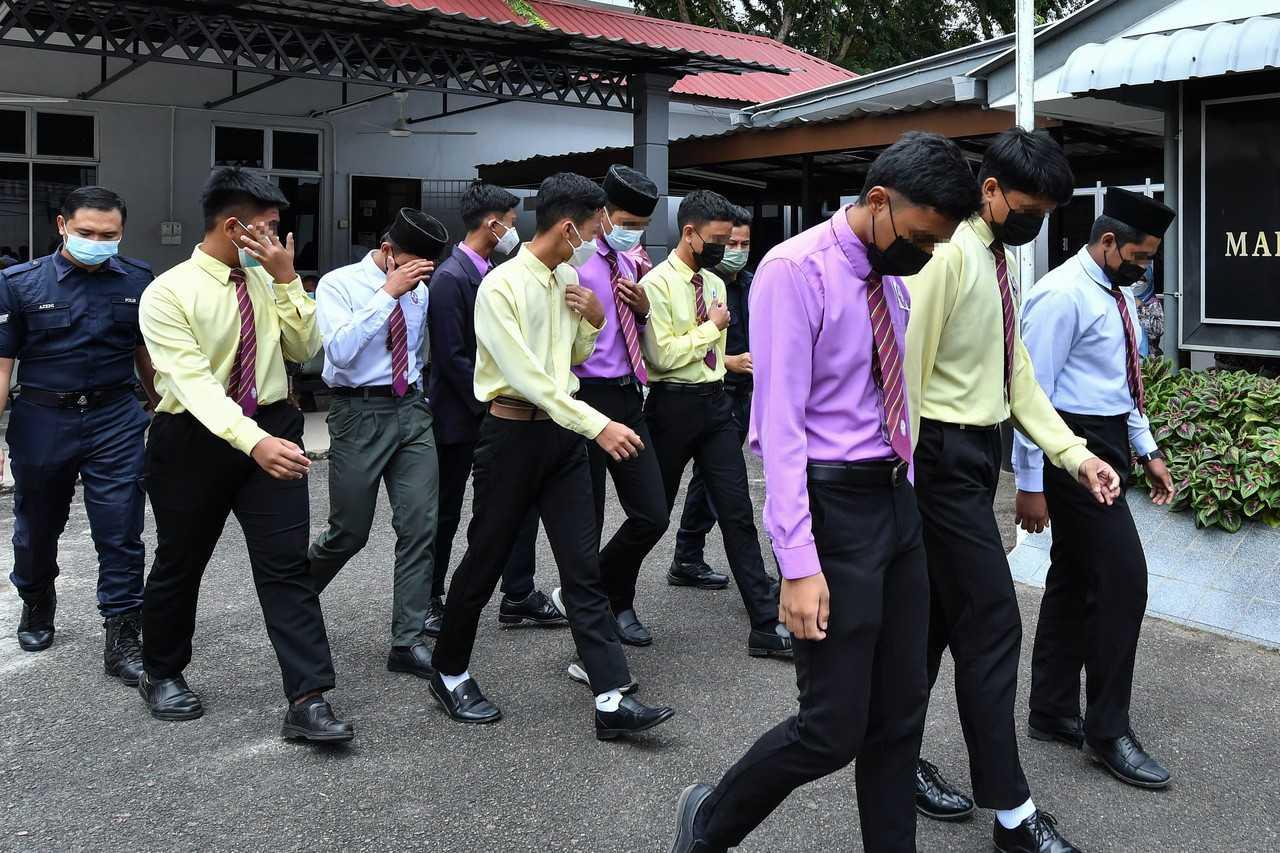 The nine students at a boarding school in Kemaman who were charged at the Magistrate's Court today with bullying. Photo: Bernama 