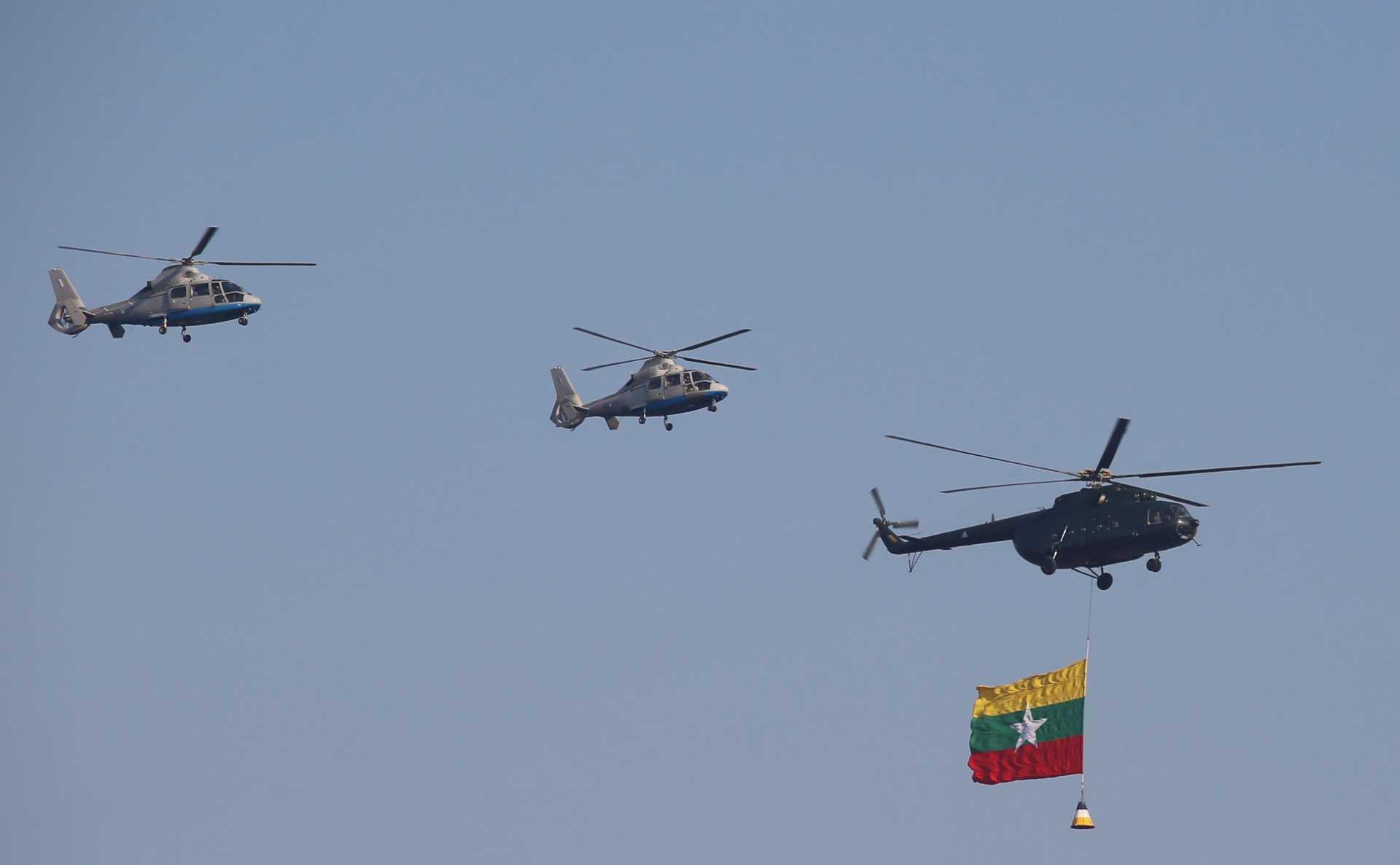 Helicopters of Myanmar's junta military fly in formation during a ceremony to mark the 75th anniversary of the country's Union Day in Naypyidaw on Feb 12. Photo: AFP 