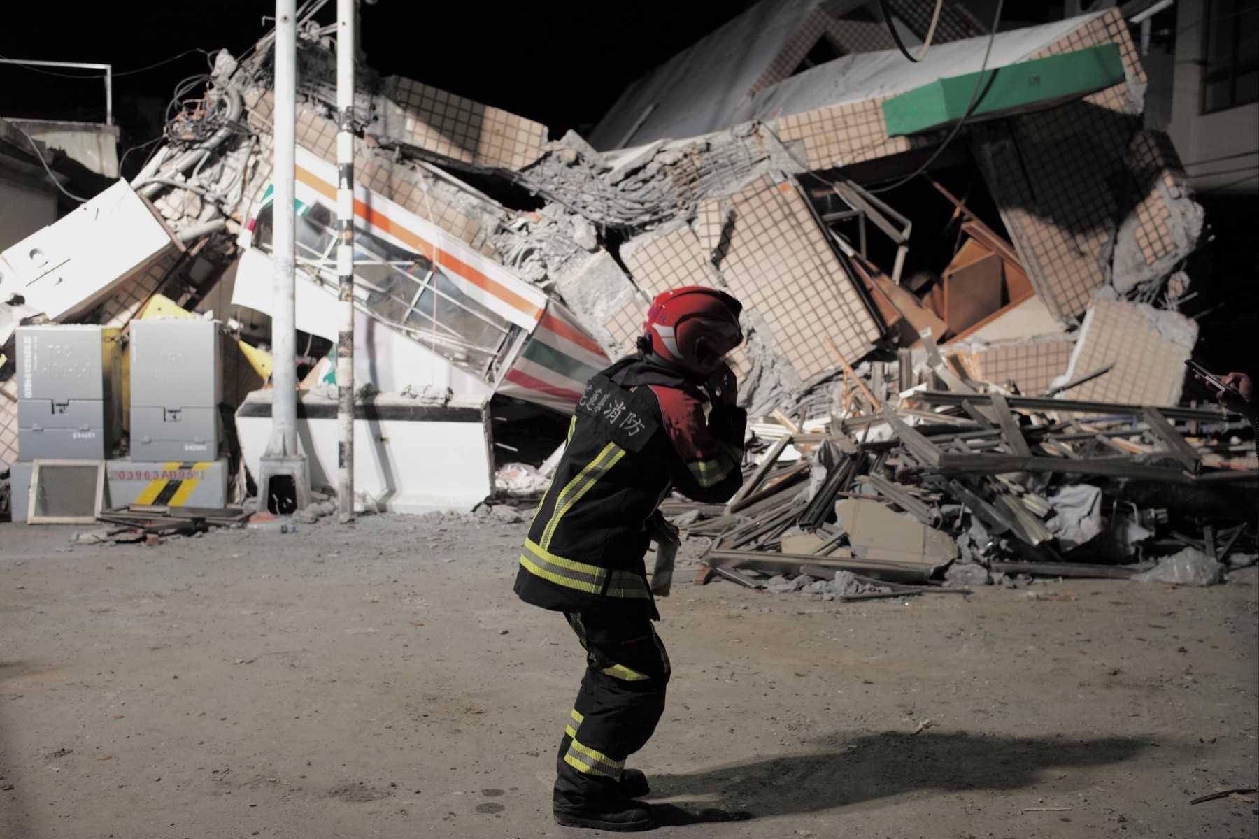 A rescuer speaks on cellphone in front of a collapsed building after an earthquake at Yuli Township in Hualien county, eastern Taiwan on Sept 18. Photo: AFP