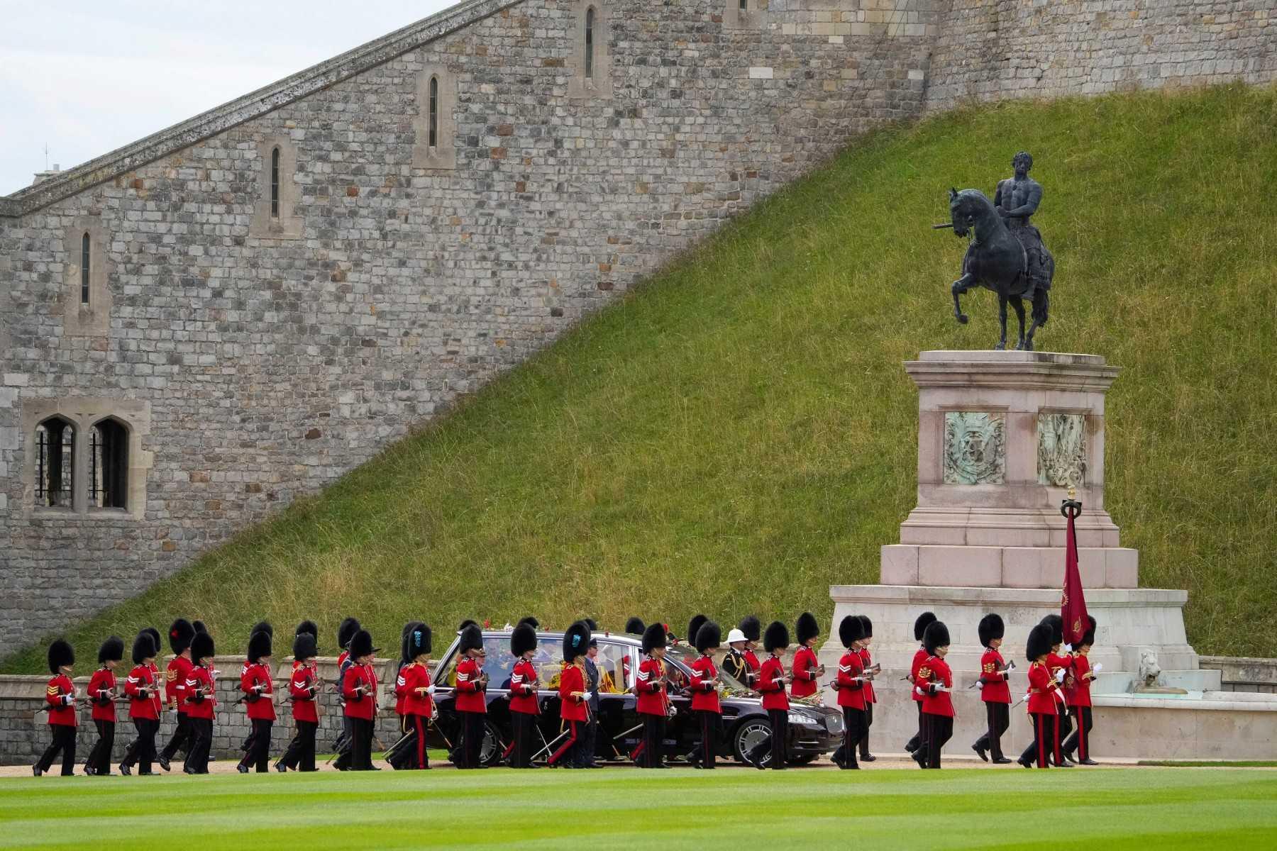 Grenadier Guards escort the coffin as the Procession following the coffin of Queen Elizabeth II, aboard the State Hearse, travels inside Windsor Castle on Sept 19, ahead of the Committal Service for Britain's Queen Elizabeth II. Photo: AFP 