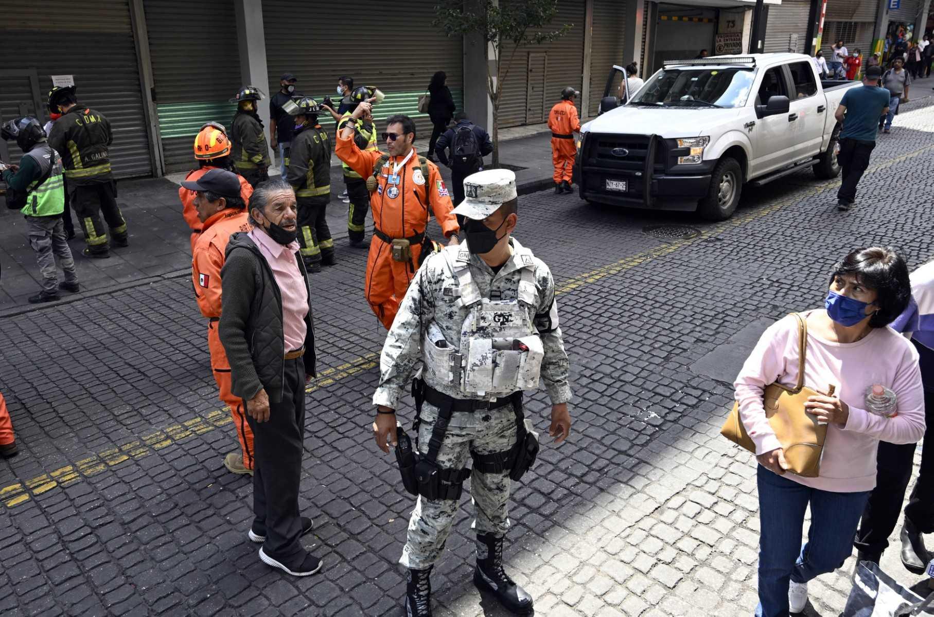 Firefighters and rescuers look at damages in a building after an earthquake in Mexico City on Sept 19. Photo: AFP