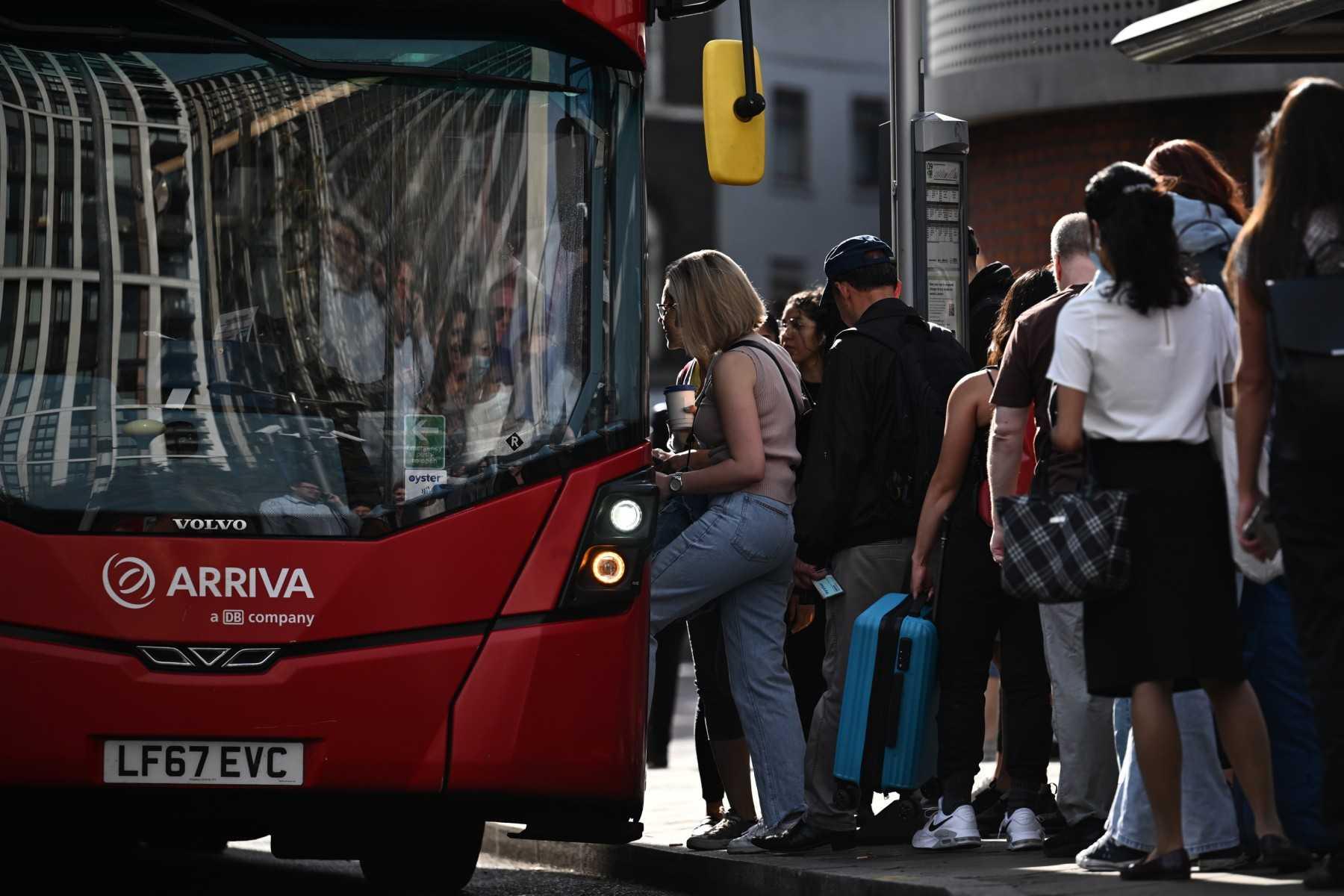 Passengers get on a bus outside Waterloo Station in London on June 21. Photo: AFP 