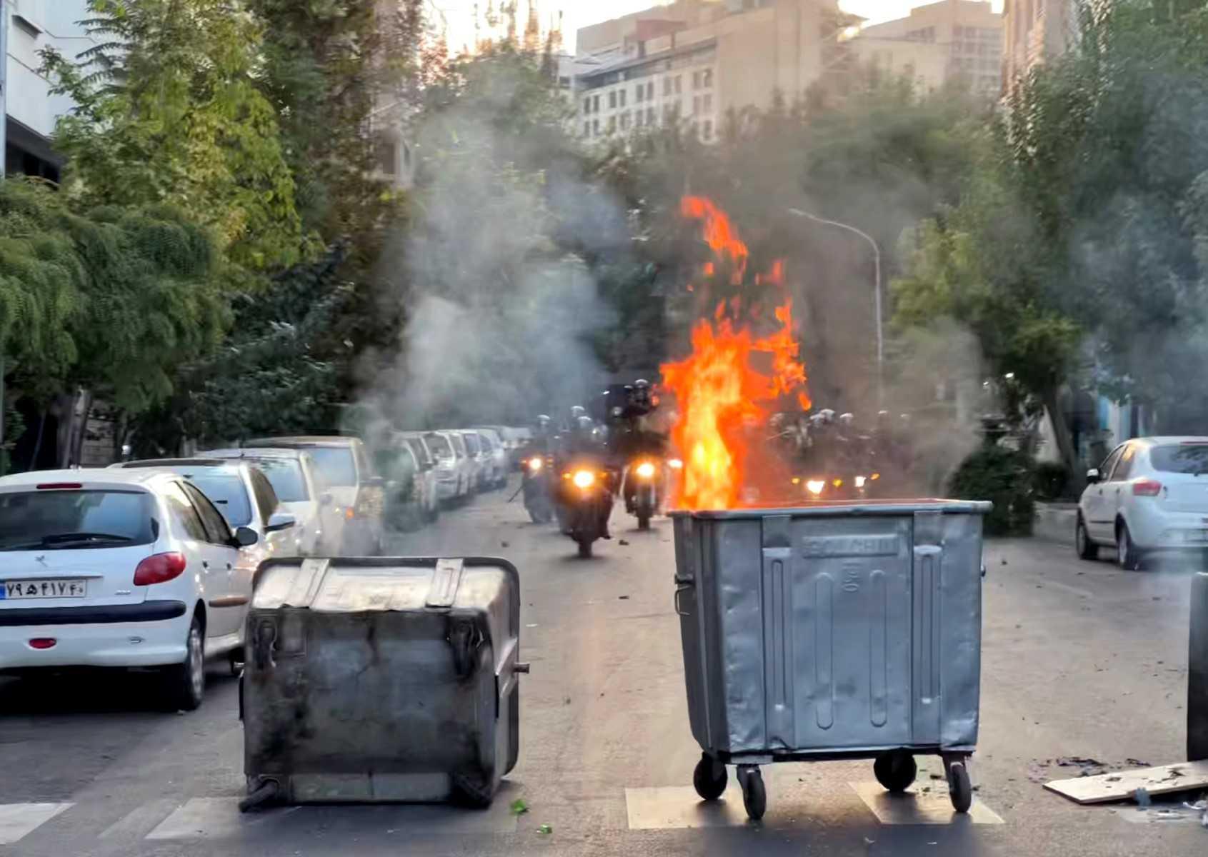 A picture obtained by AFP outside Iran shows a bin burning in the middle of an intersection during a protest for Mahsa Amini, a woman who died after being arrested by the Islamic republic's 'morality police, in Tehran on Sept 20. Photo: AFP
