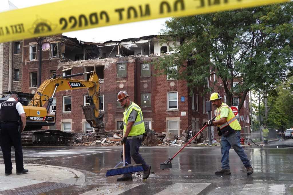 Workers clean up and secure an apartment building that was heavily damaged by an explosion on Sept 20, in Chicago, Illinois. Photo: AFP