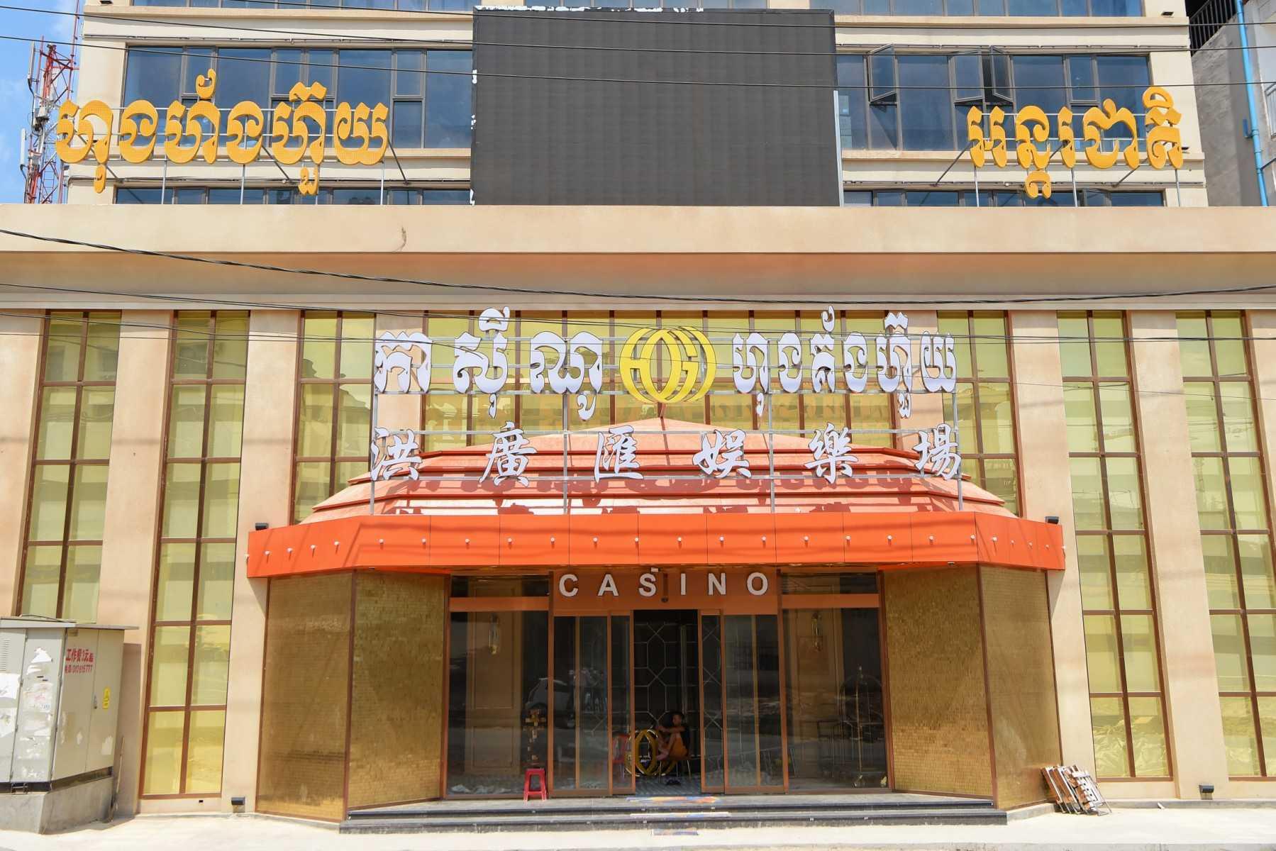 A man sits inside a casino in Sihanoukville on Feb 18, 2020. Victims of rackets say they are lured into Cambodia by promises of high-paying jobs at casinos and hotels. Photo: AFP 