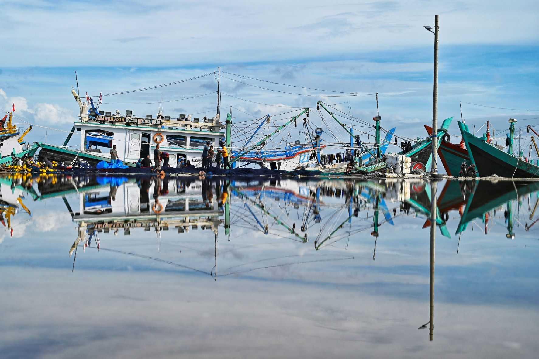 Fishermen check their nets during 'no fishing Friday' at a port in Banda Aceh on Sept 2. Photo: AFP