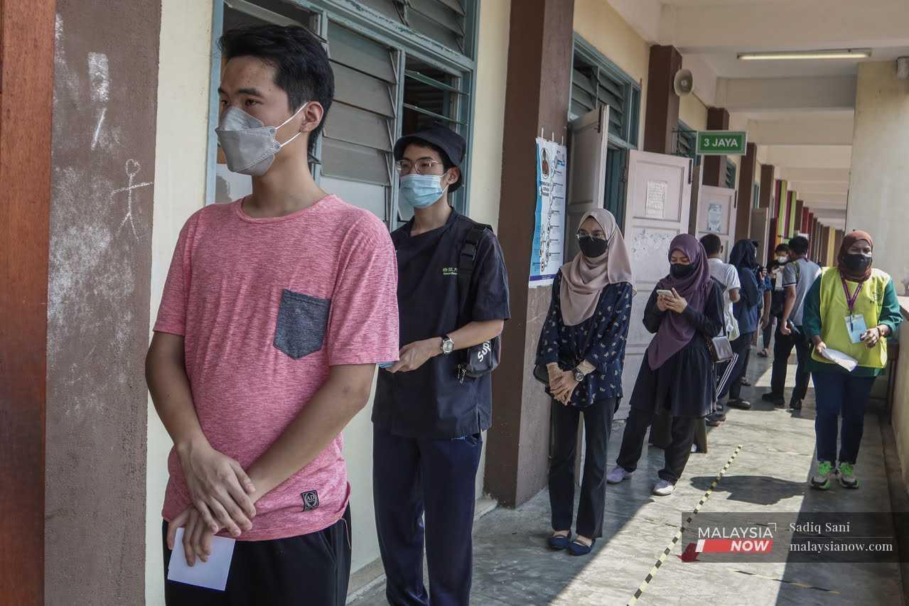 Young voters queue at a polling centre in Muar, Johor, during the state election on March 12. 
