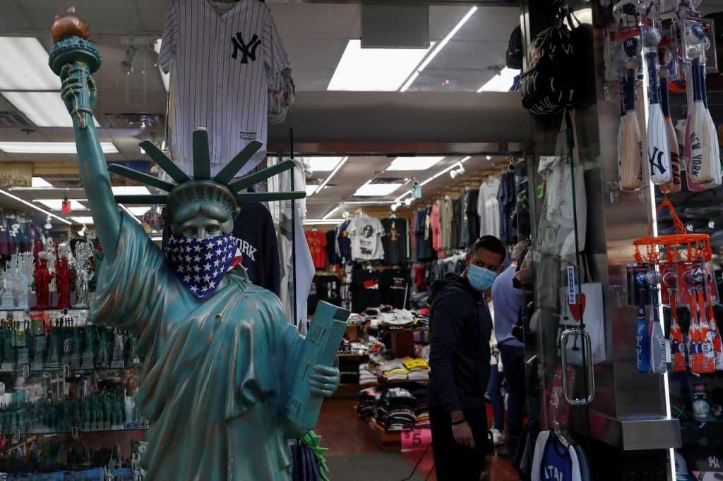 A man wearing a protective face mask looks out a storefront window in the Little Italy section of Manhattan in New York City, in this Oct 1, 2021 file photo. Photo: Reuters
