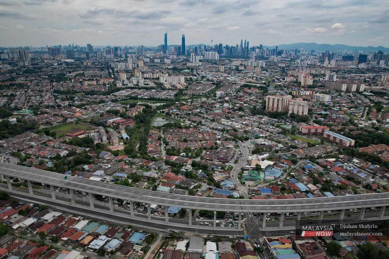 Office and residential buildings are seen along the Sungai Besi-Ulu Kelang Elevated Expressway in the Tasek Tambahan Ampang in Selangor. 

