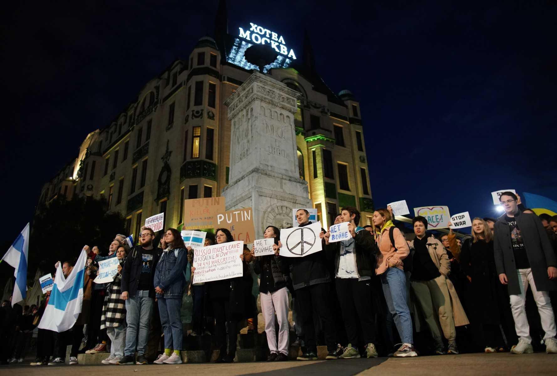 People hold anti-war banners during a protest outside the 'Hotel Moscow' in Belgrade on Sept 21, after Russia President dramatically escalated his seven-month war in Ukraine by calling up 300,000 military reservists. Photo: AFP