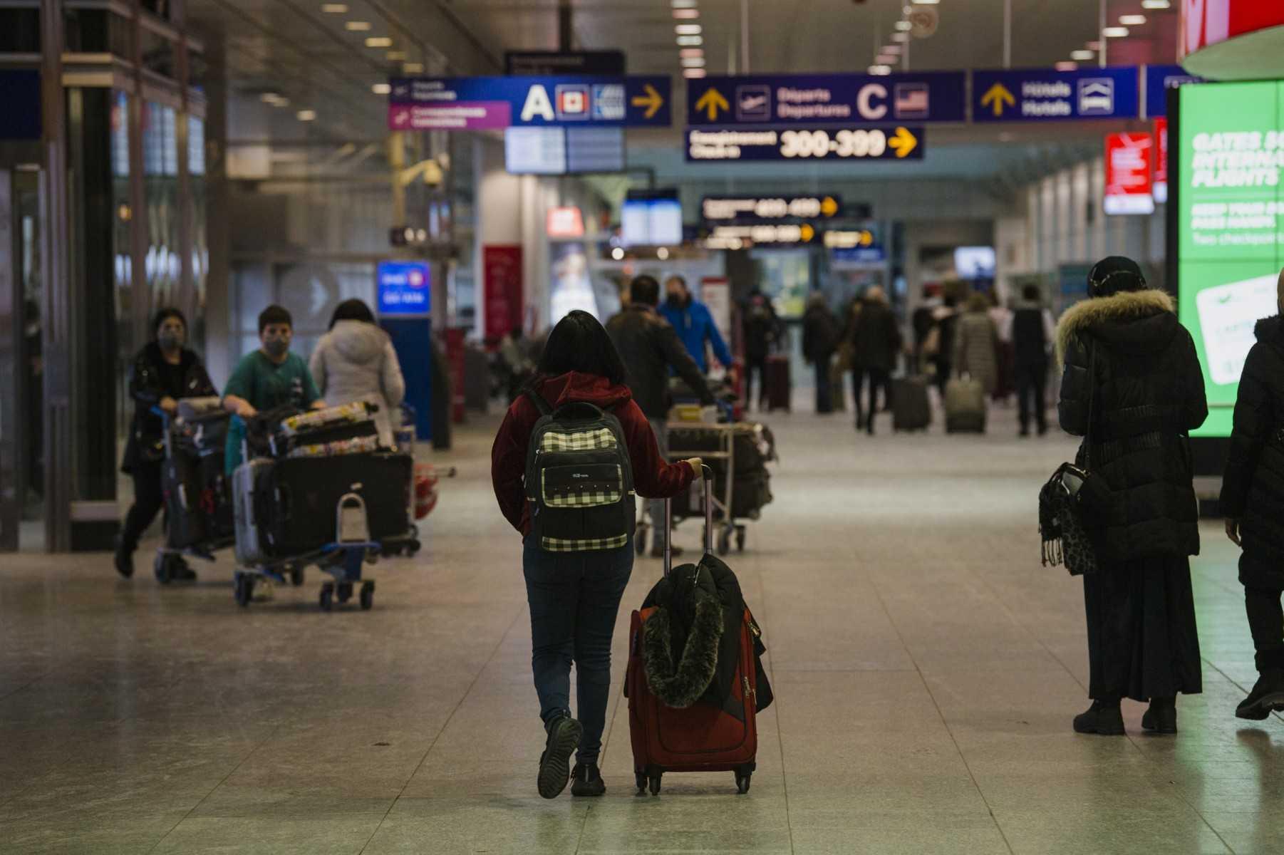 Travellers walk through the terminal at Montreal-Pierre Elliott Trudeau International Airport during a winter storm in Montreal, Quebec on Jan 17. Photo: AFP