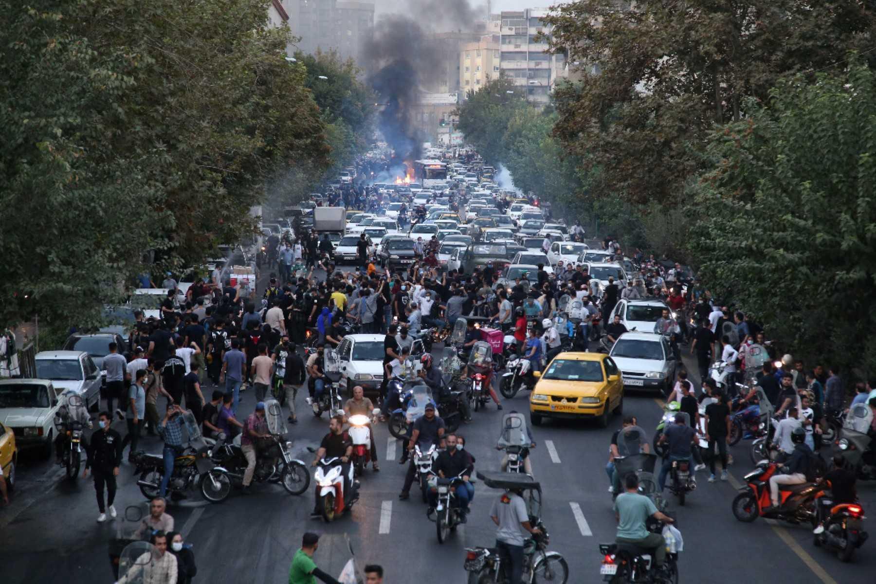 A picture obtained by AFP outside Iran on Sept 21, shows Iranian demonstrators taking to the streets of the capital Tehran during a protest for Mahsa Amini, days after she died in police custody. Photo: AFP 
