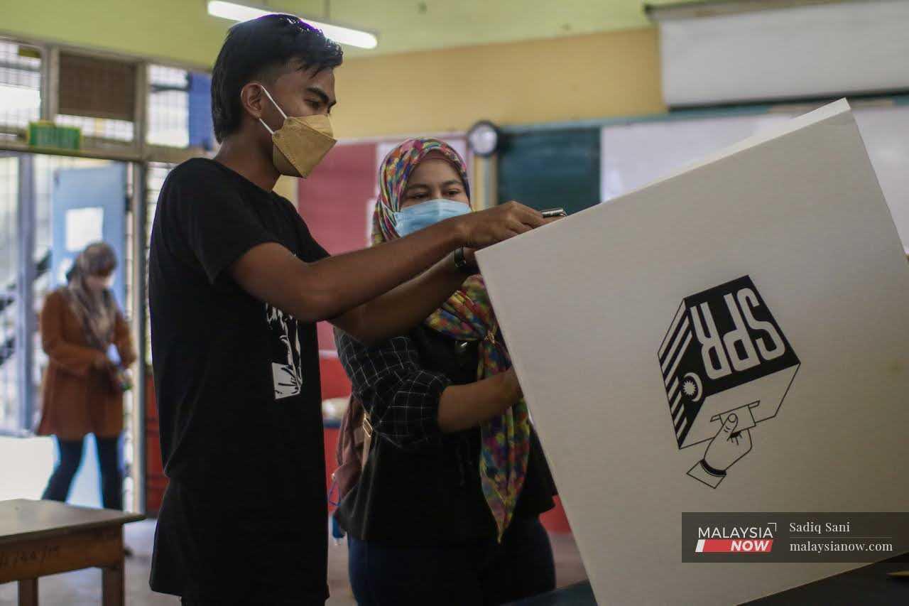 Election Commission workers prepare a polling centre ahead of the Johor state election in March.